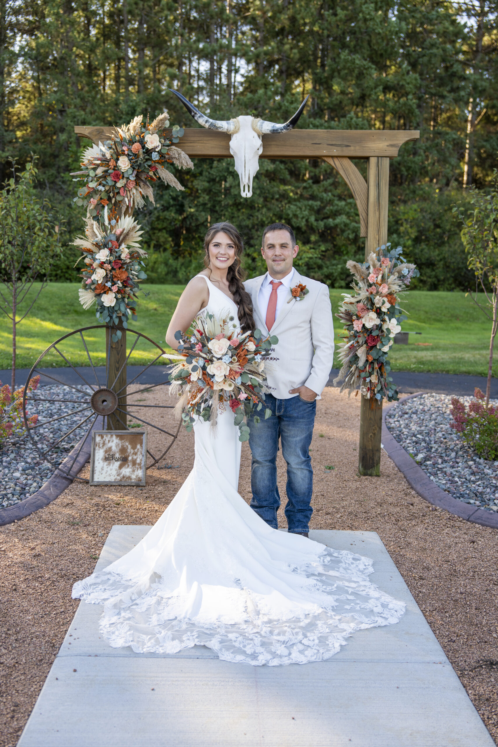 A bride and groom portrait under the ceremony arch.