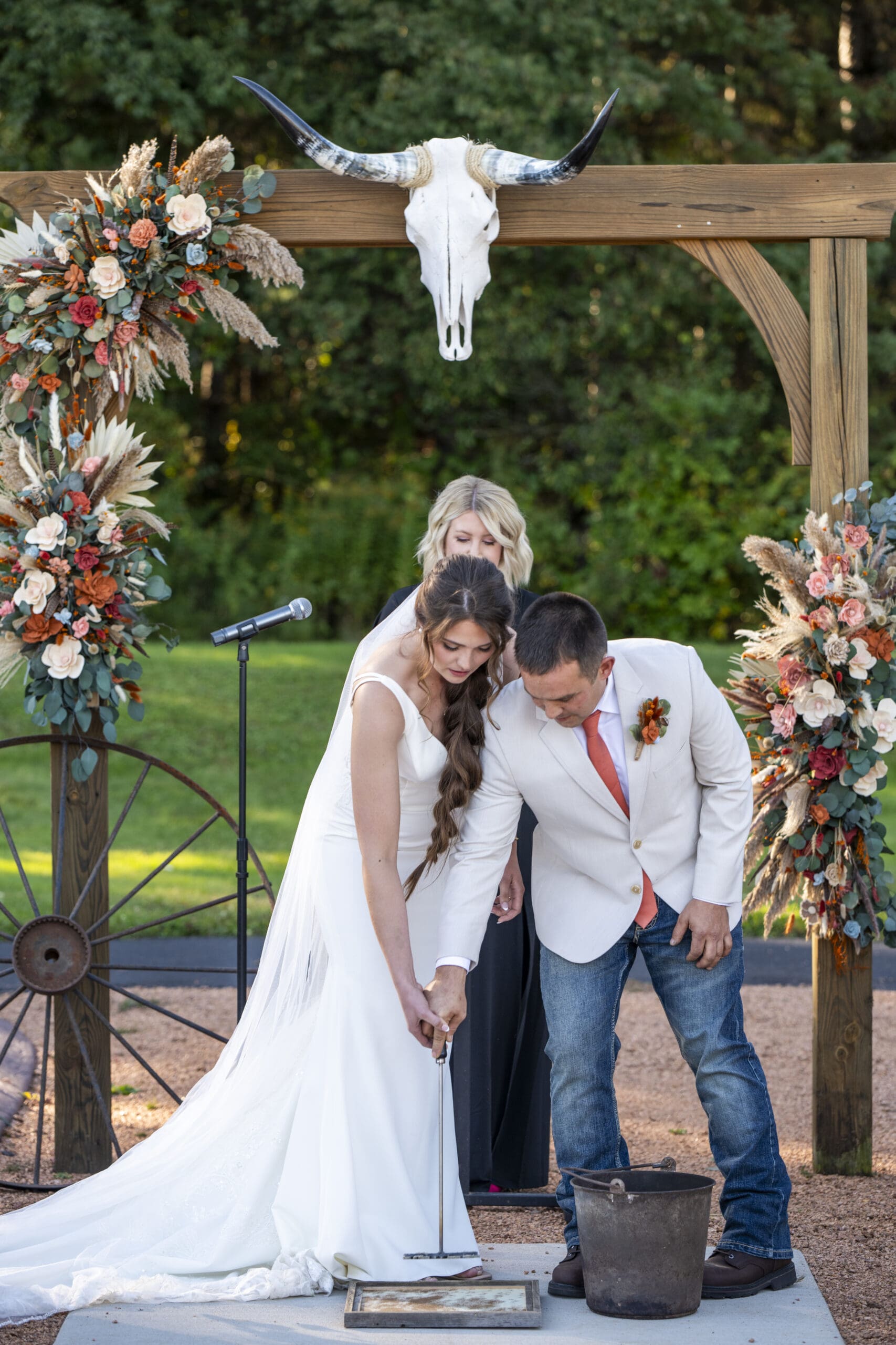 Groom and Bride doing a branding during their ceremony.
