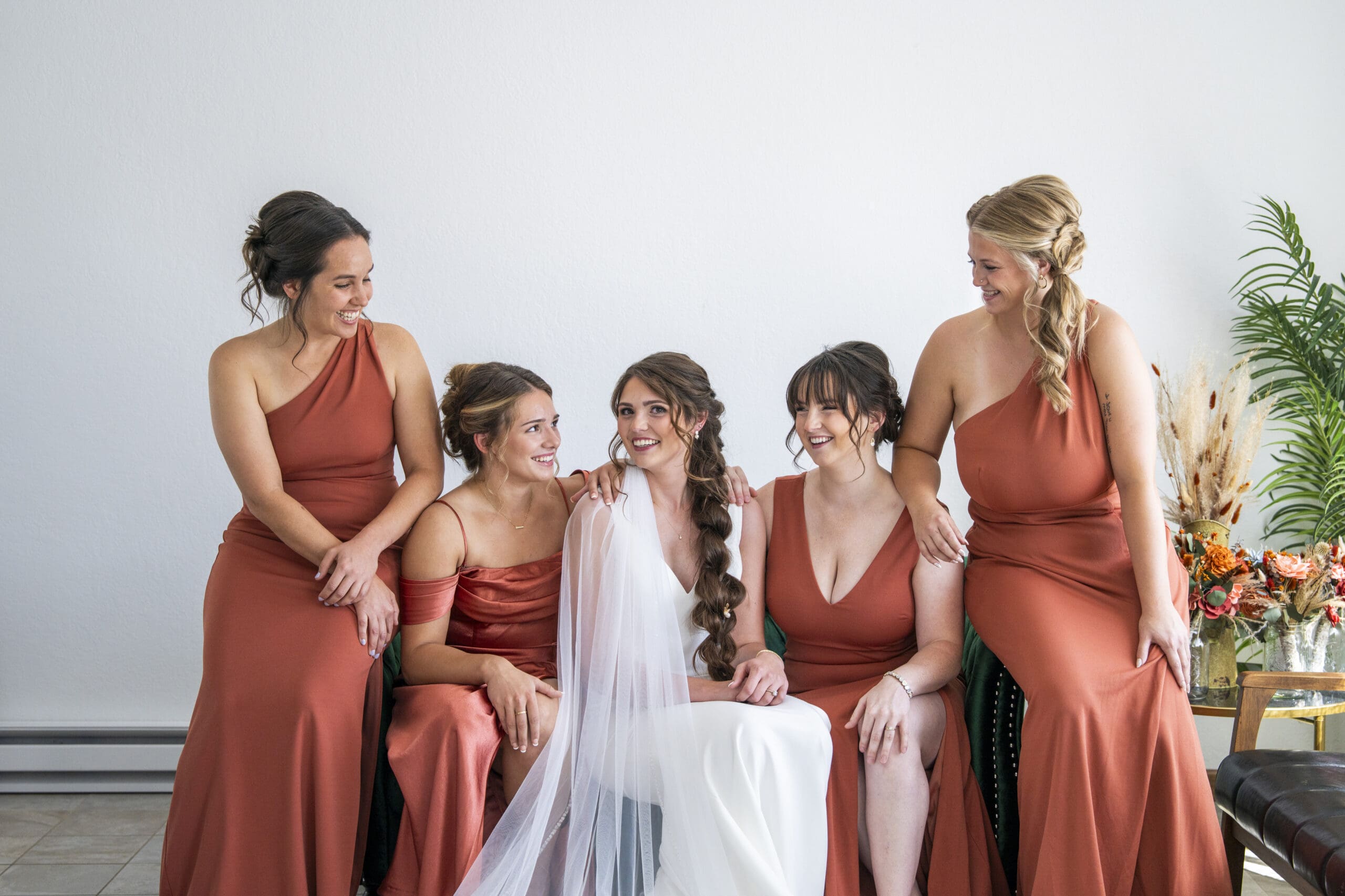 The bridesmaids with the bride on the green sofa in Central WI.