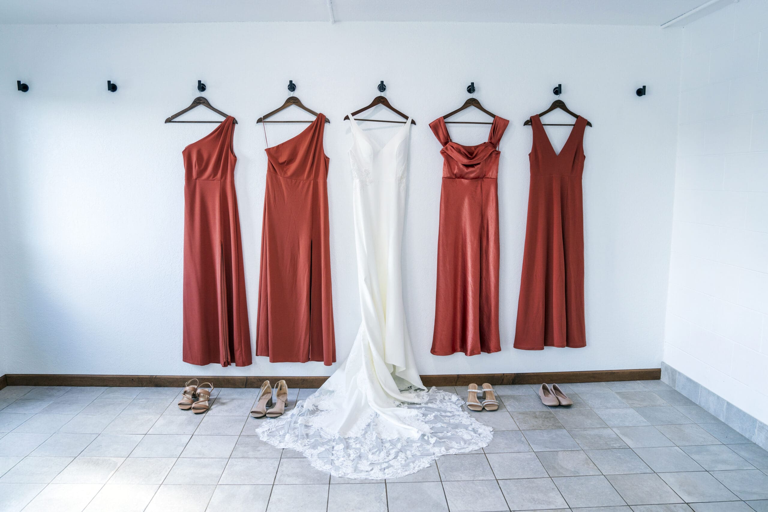 Wisconsin wedding and bridesmaids dresses hanging up on the wall at The Bailiwick in Medford.