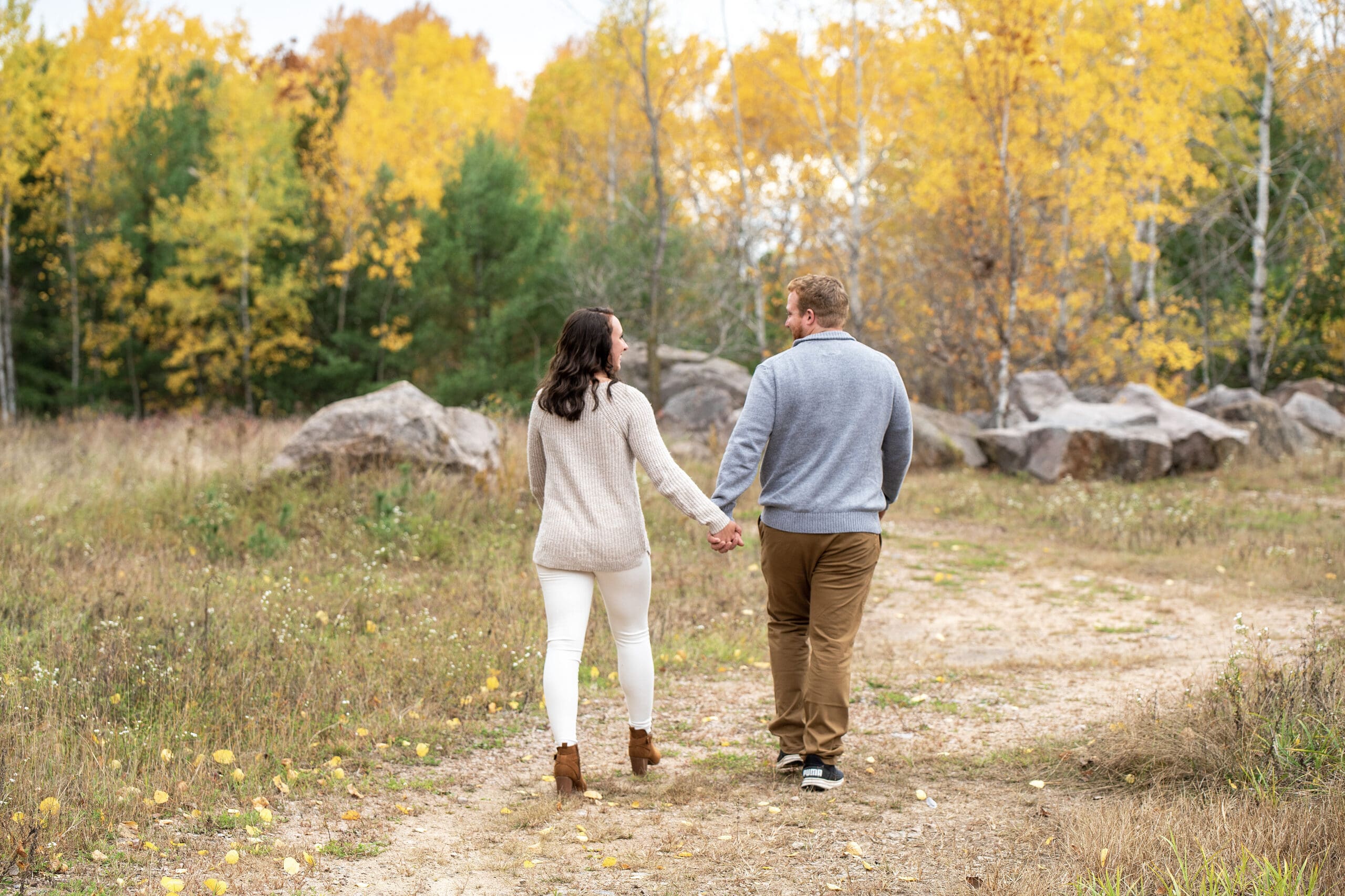 Couple walking during a fall Wisconsin photo session. 