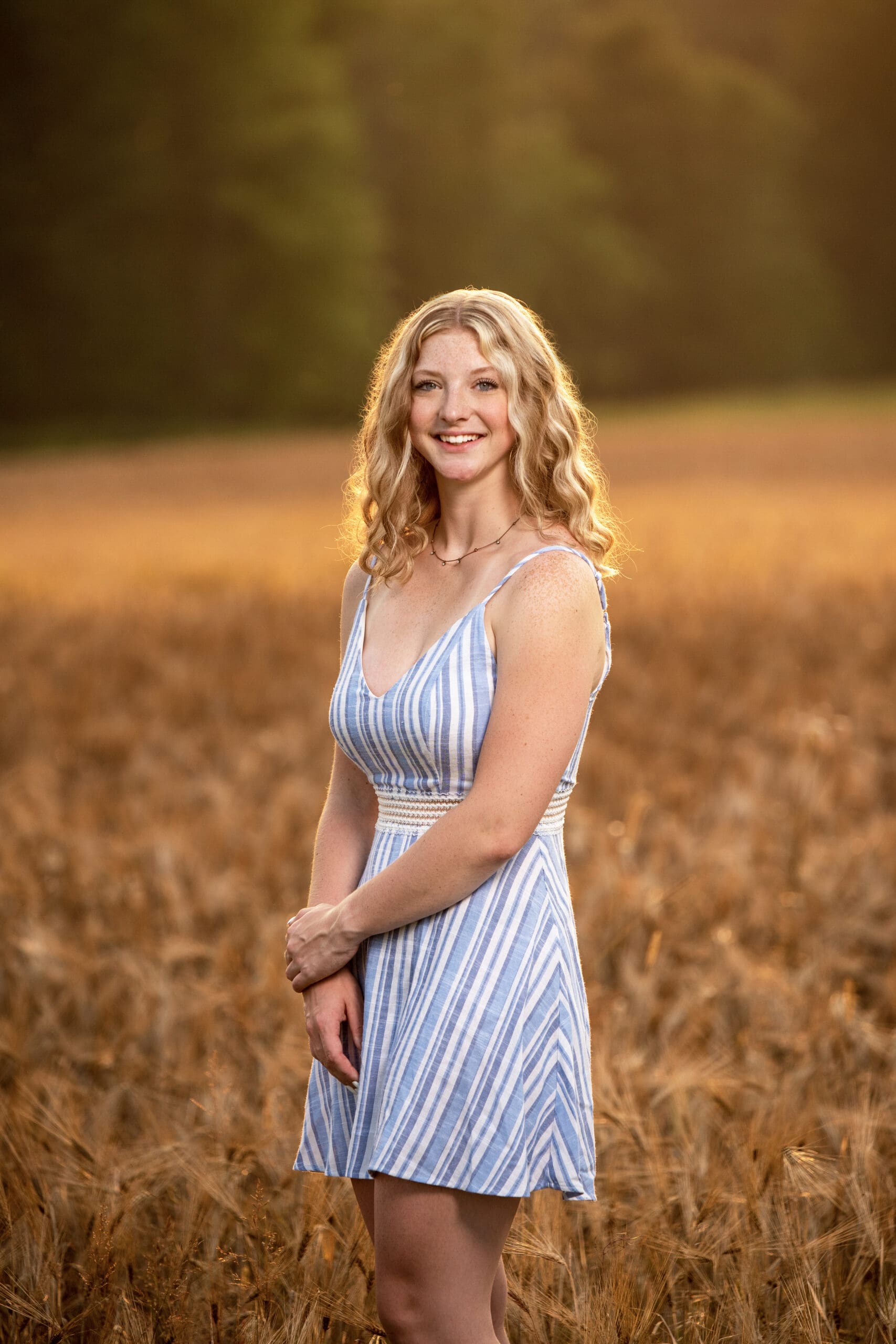 Waukesha high school senior girl standing in a weat field.