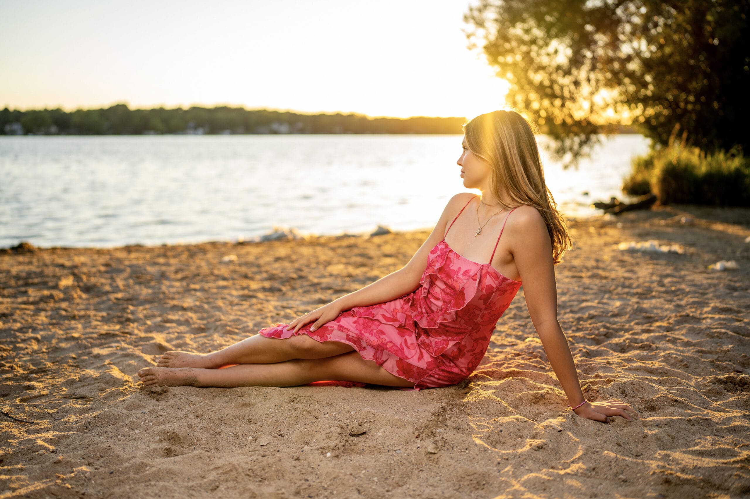 Class of 2026 Kettle Moraine senior sitting on the beach at sunset — best time to take senior pictures