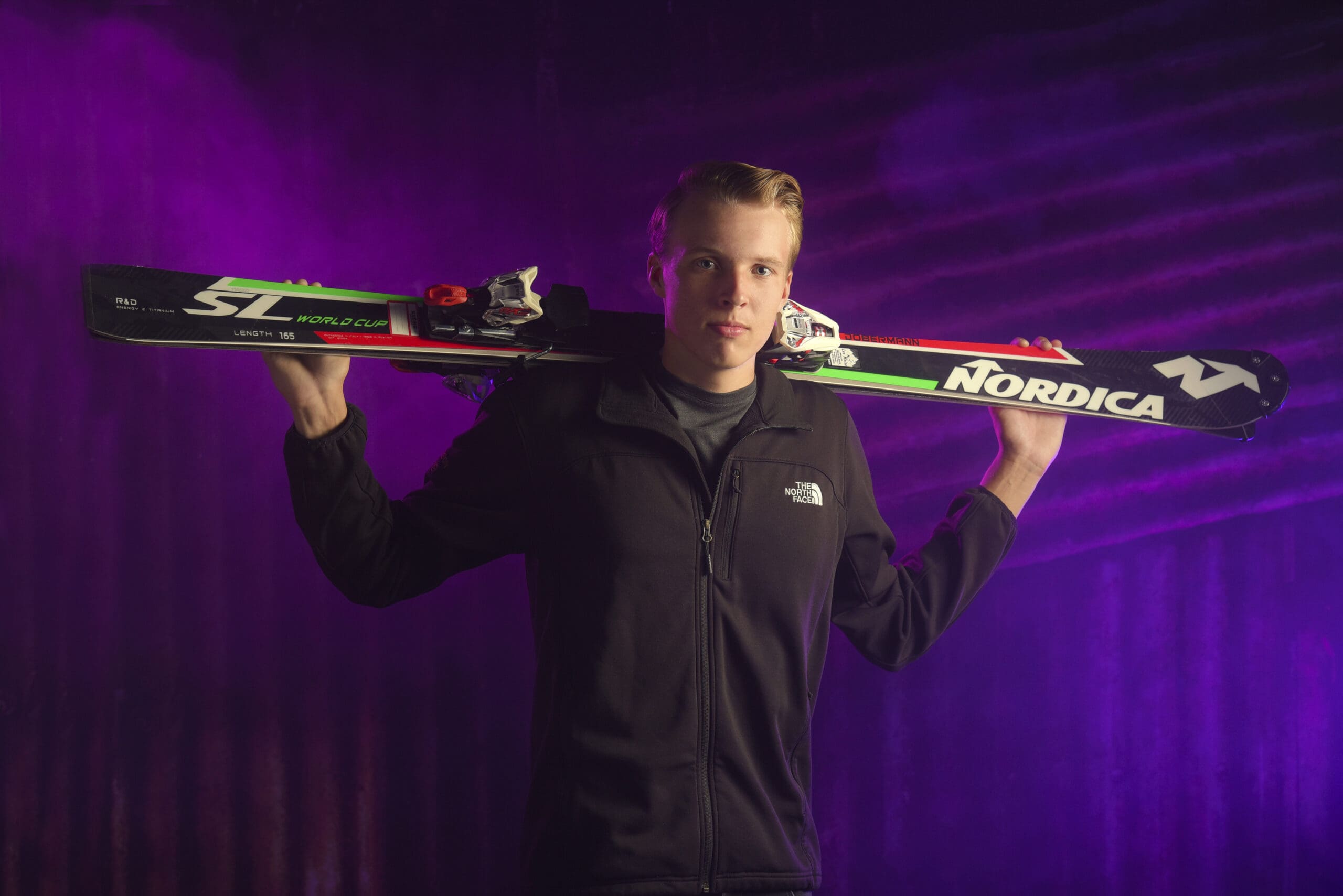 Oconomowoc senior holding his ski at the studio. 