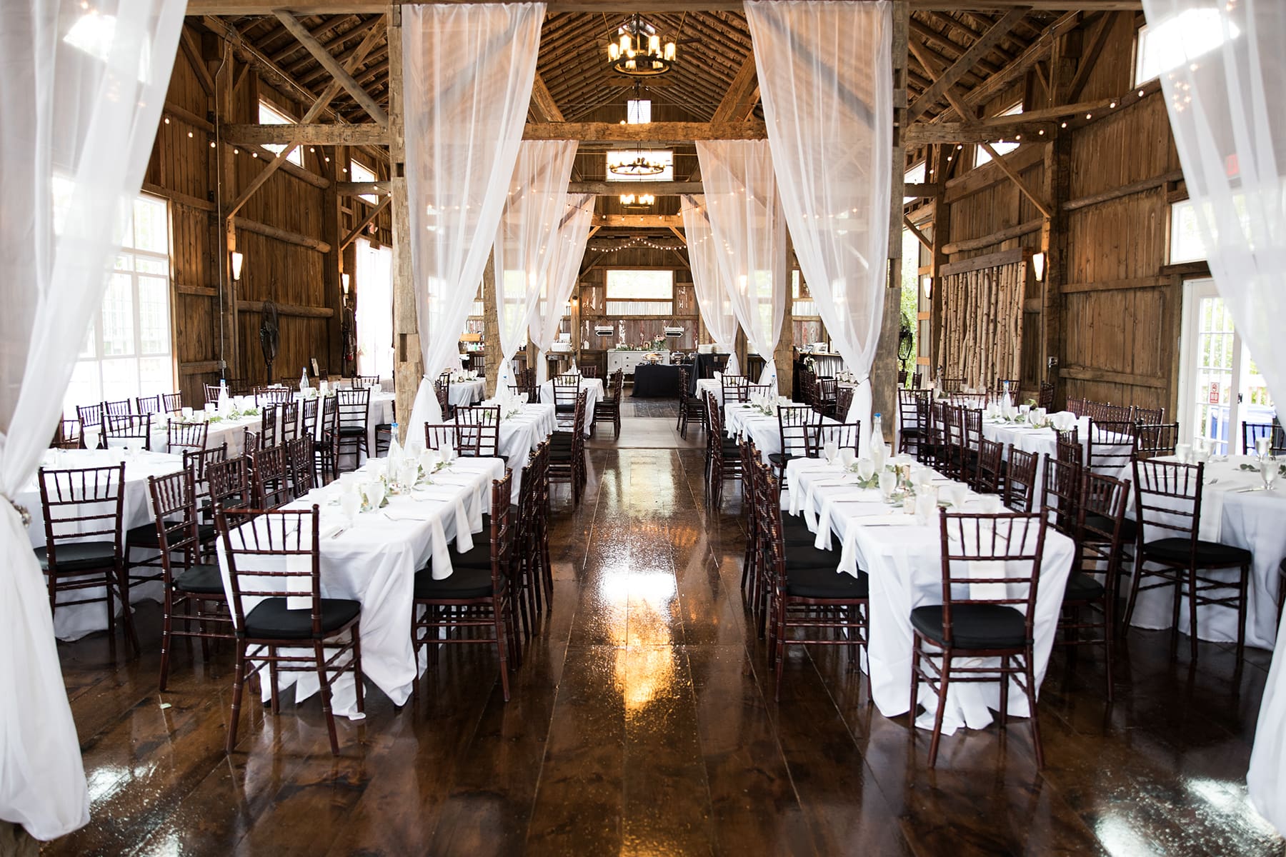 Wooden beams and open-air barn doors at Cupola Barn wedding venue in Wisconsin