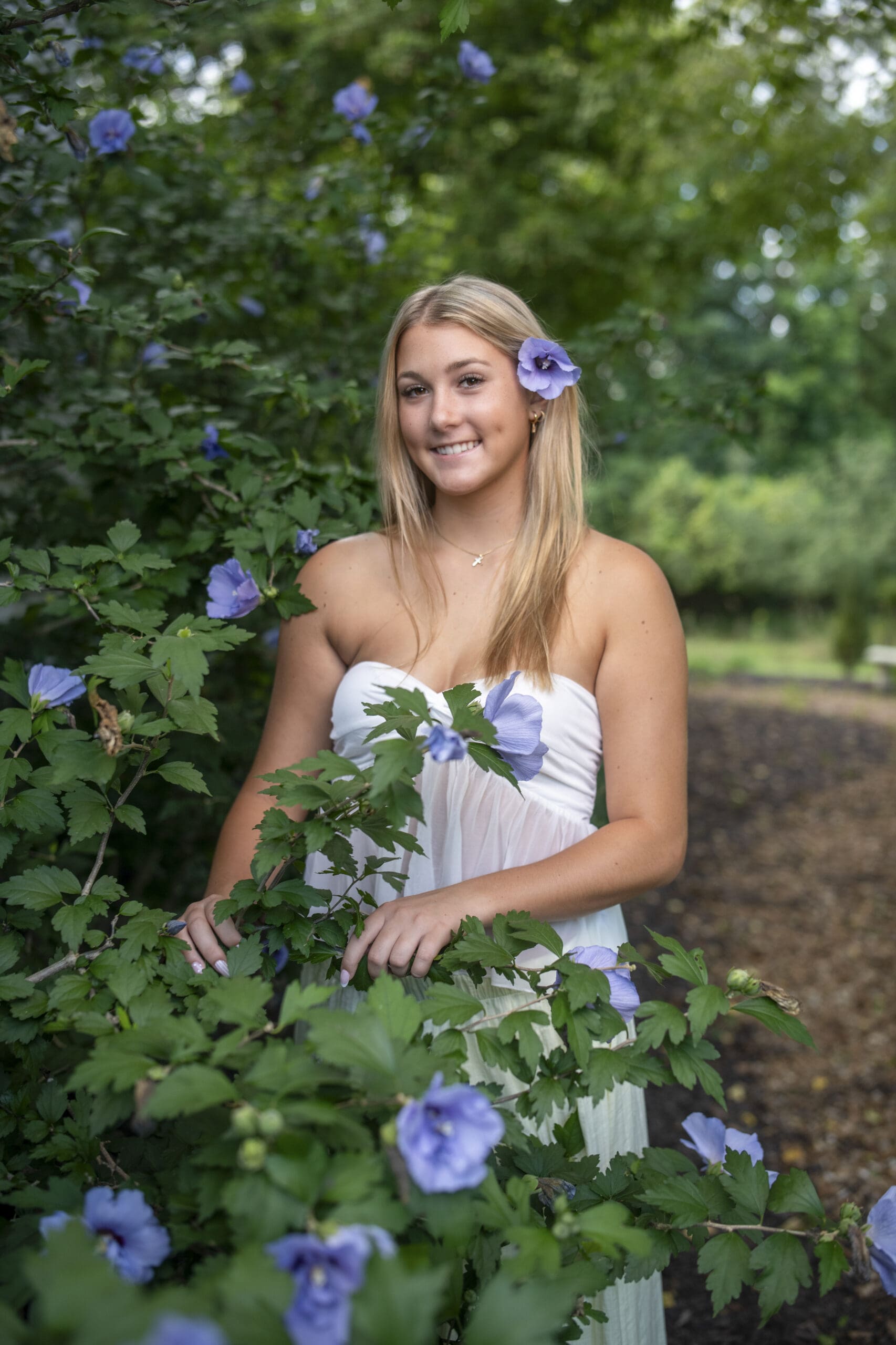 Arrowhead High School senior posing next to a flower tree during golden hour — best time to take senior pictures
