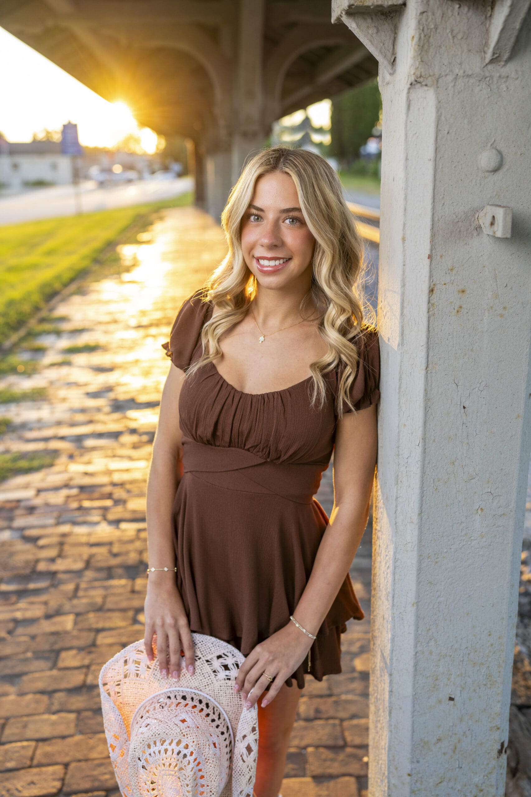 Arrowhead senior girl leaning against beam in downtown Oconomowoc. 