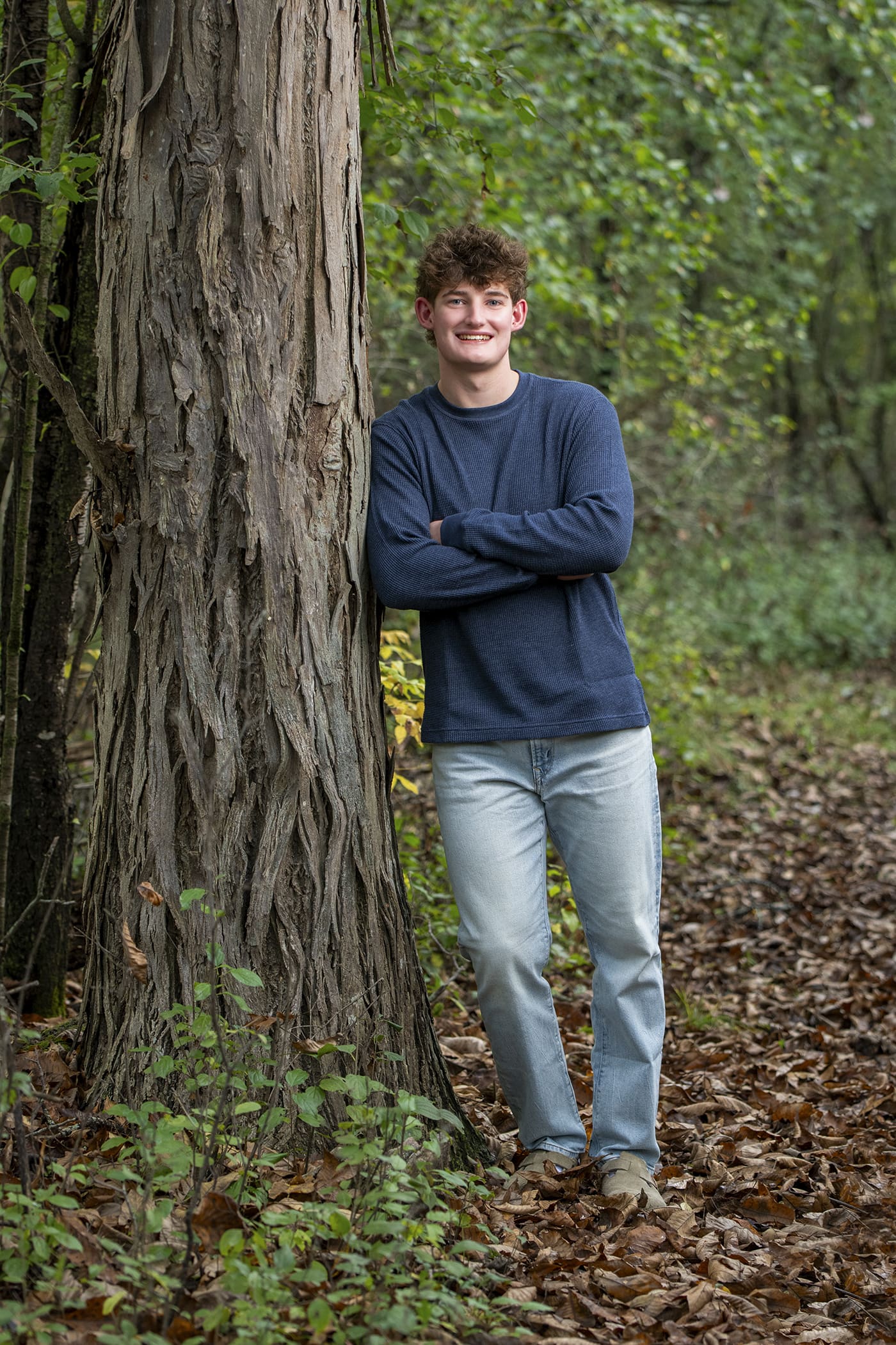 Arrowhead senior leaning against tree in Merton, WI - senior portrait tips. 