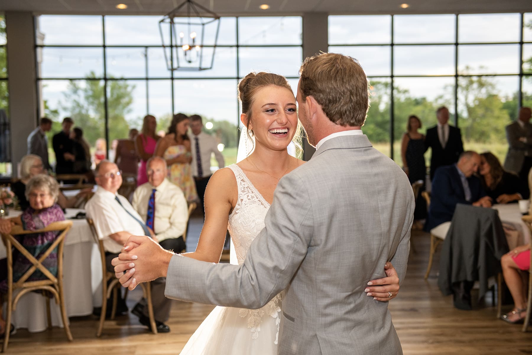 Close up of bride laughing dancing with her husband at Lac La Belle