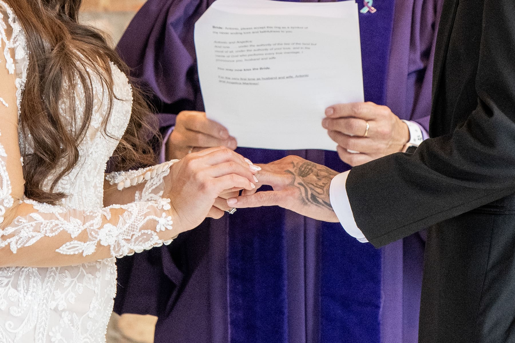 Groom and bride exchanging rings during wedding ceremony 