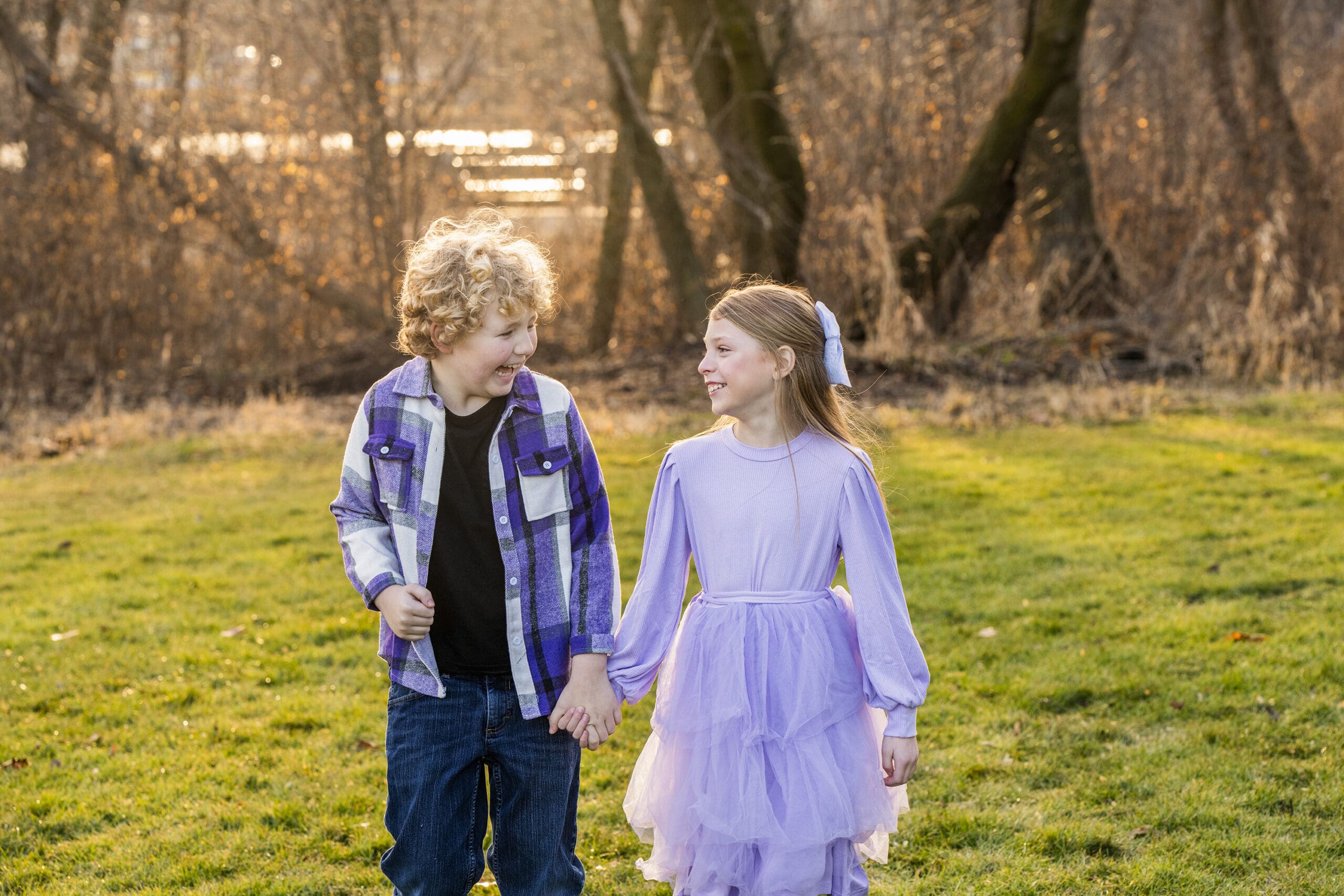 Siblings interacting naturally while showcasing family photo outfit ideas for outdoor sessions.