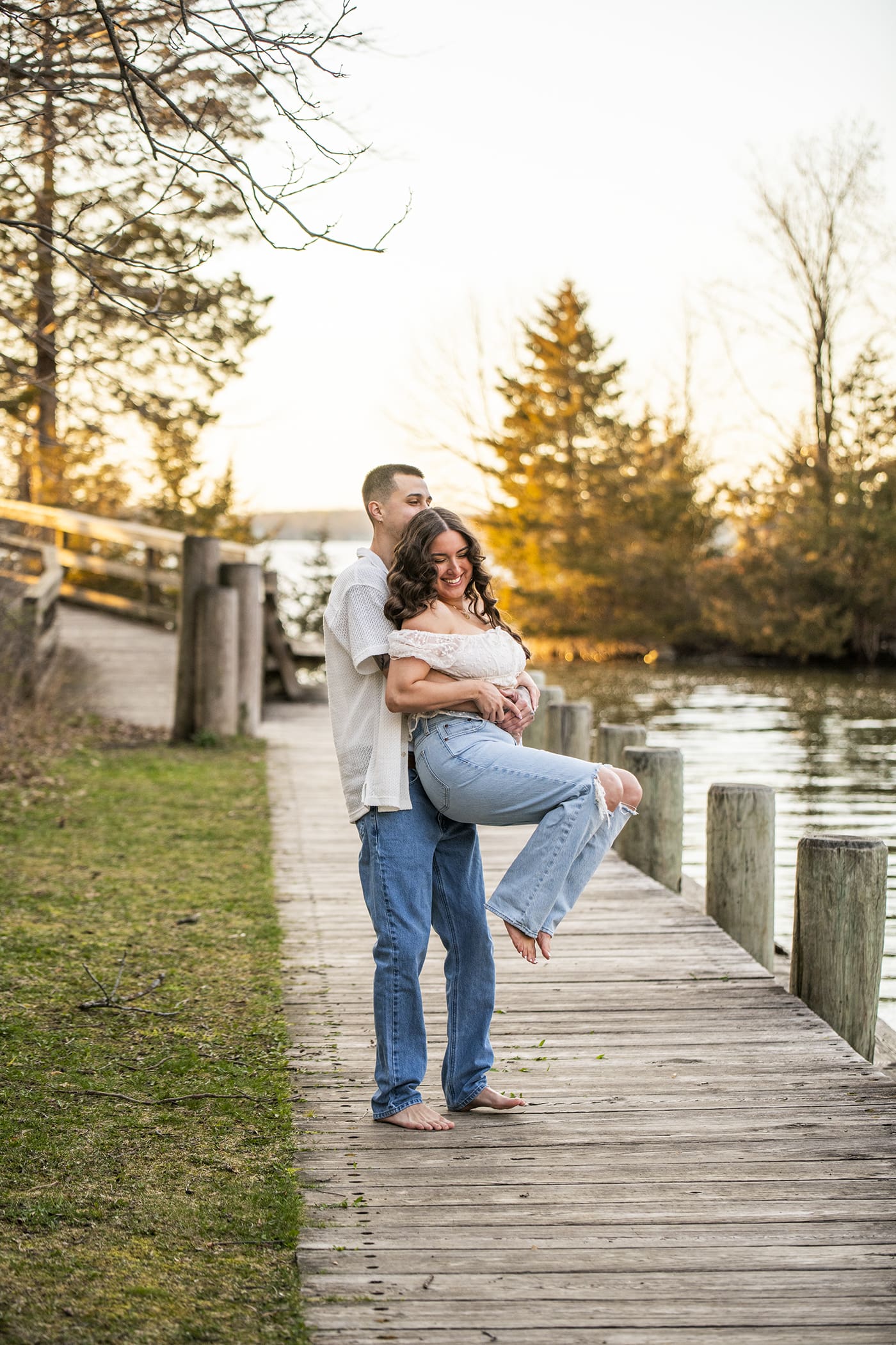 Engaged couple spinning and laughing during engagement sessions in Waukesha County