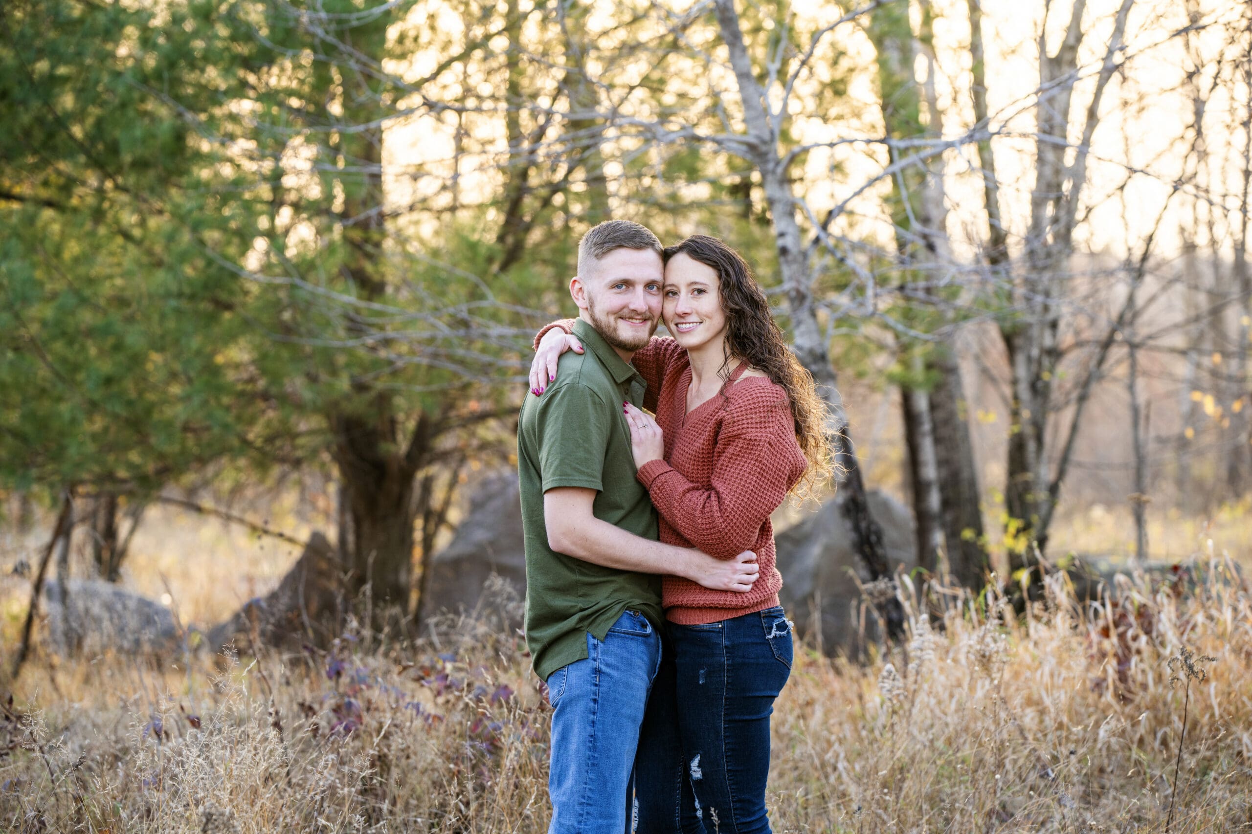 Engaged couple embracing during golden hour in Waukesha