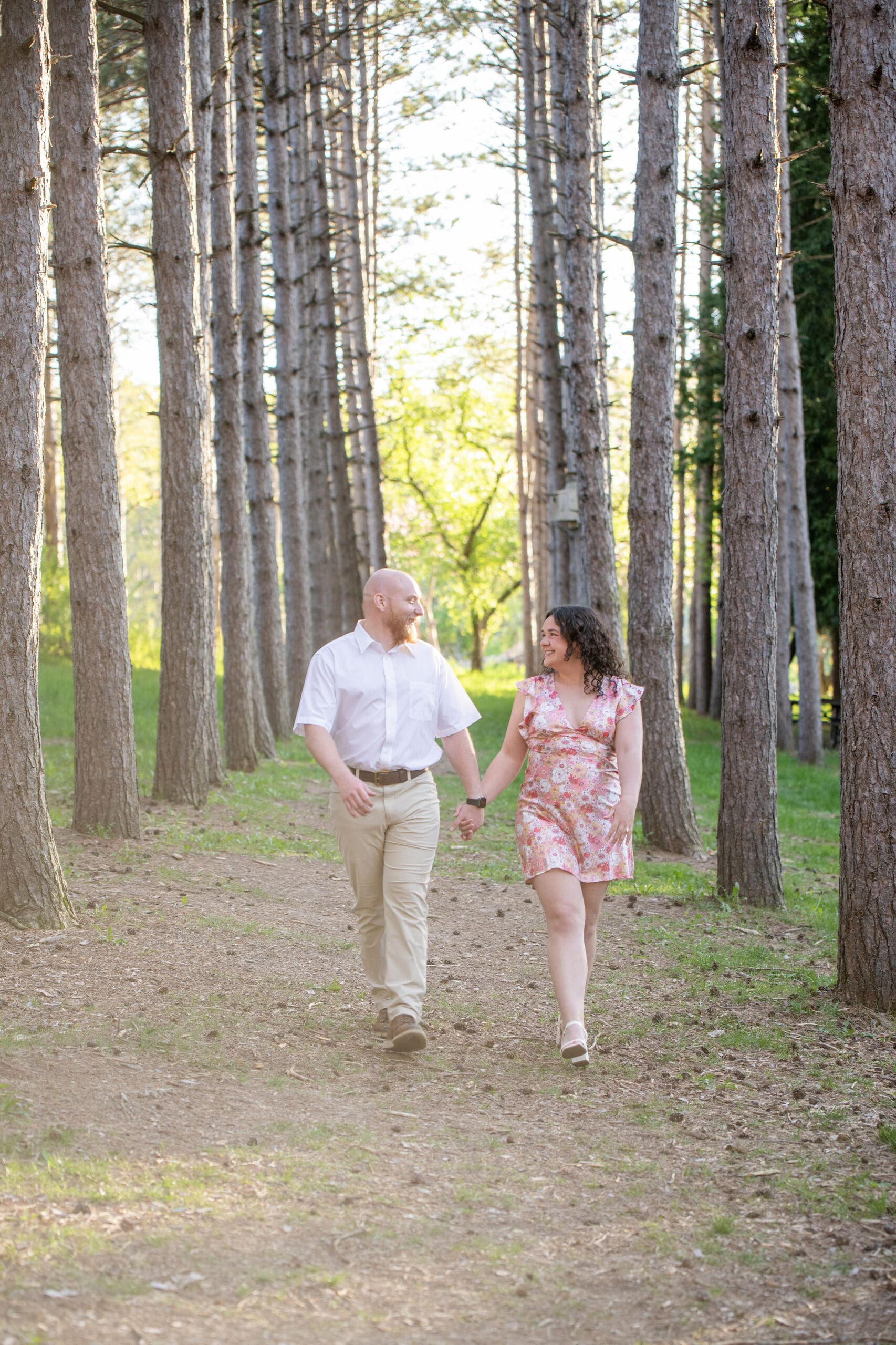 Couple holding hands while walking for engagement photos in Waukesha County