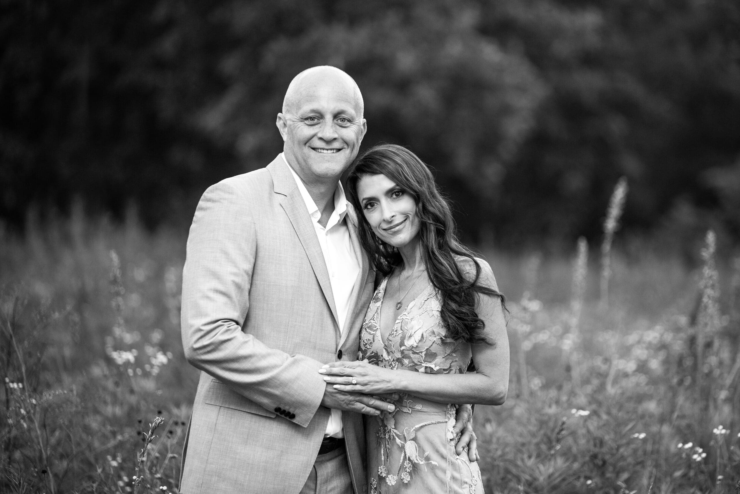 Engaged couple smiling during their engagement photos in Delafield. 