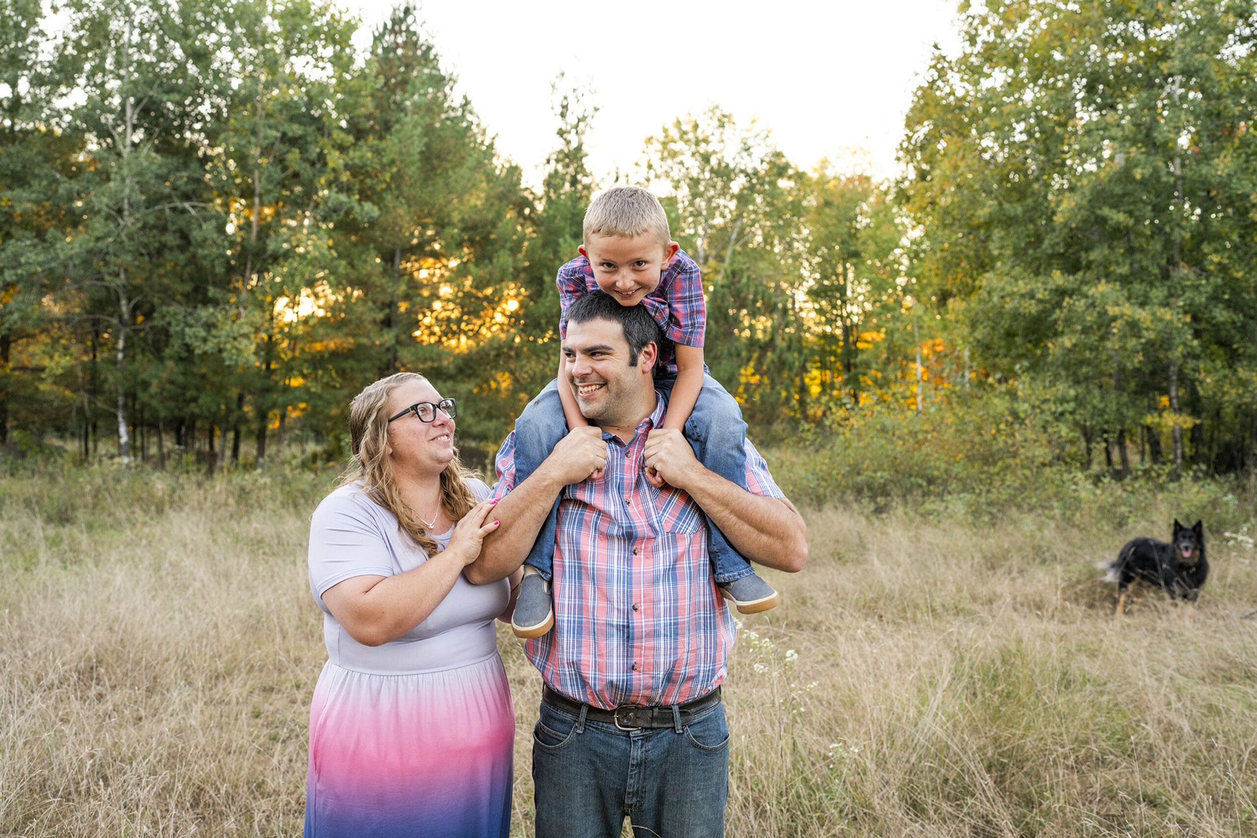 Delafield family playing in the field during golden hour.