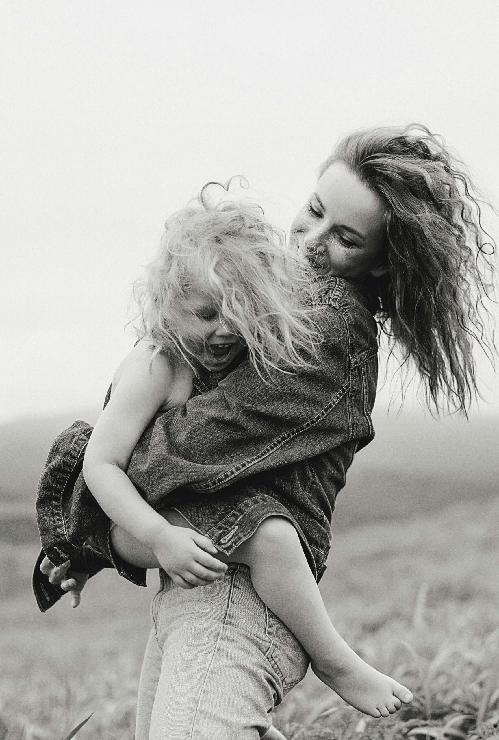 Delafield mother holding her young child during an outdoor family photo session in Wisconsin.