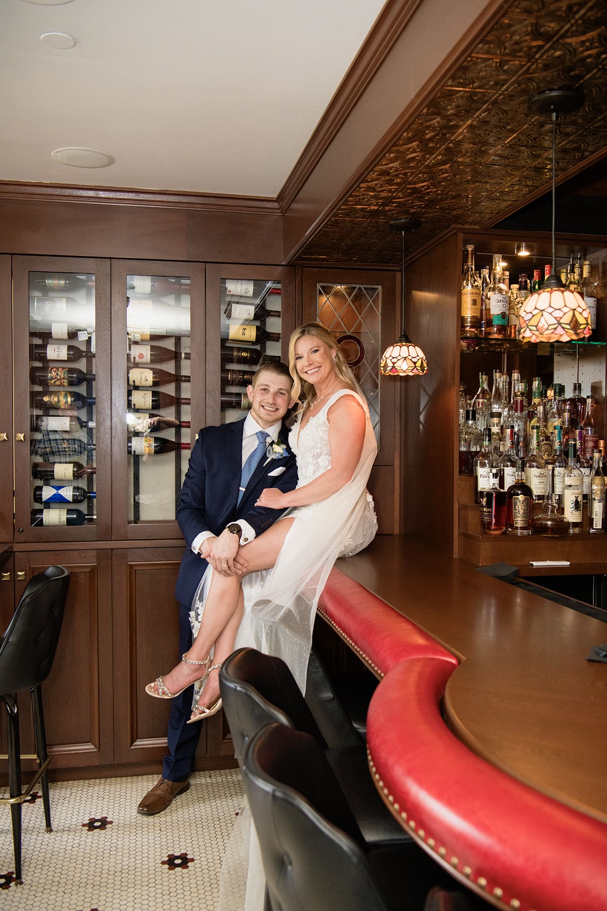 Delafield bride and groom sitting on the historic bar in Delafield