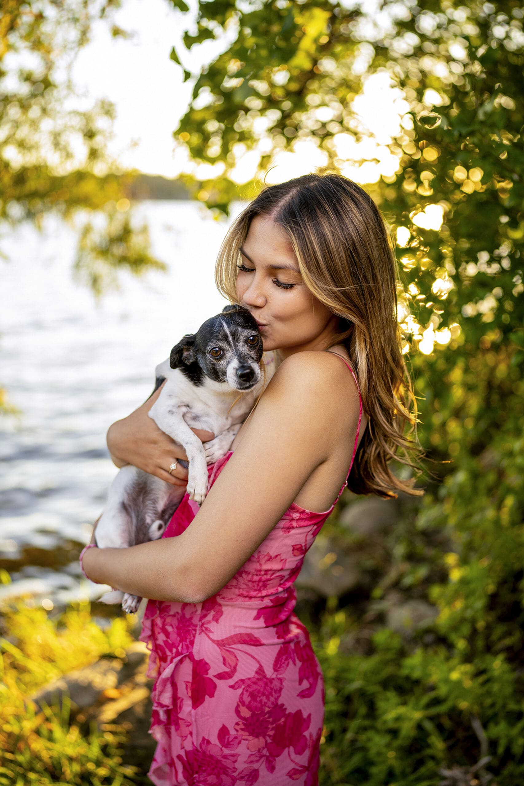 Delafield WI senior kissing her dog near the water- senior portrait tips. 