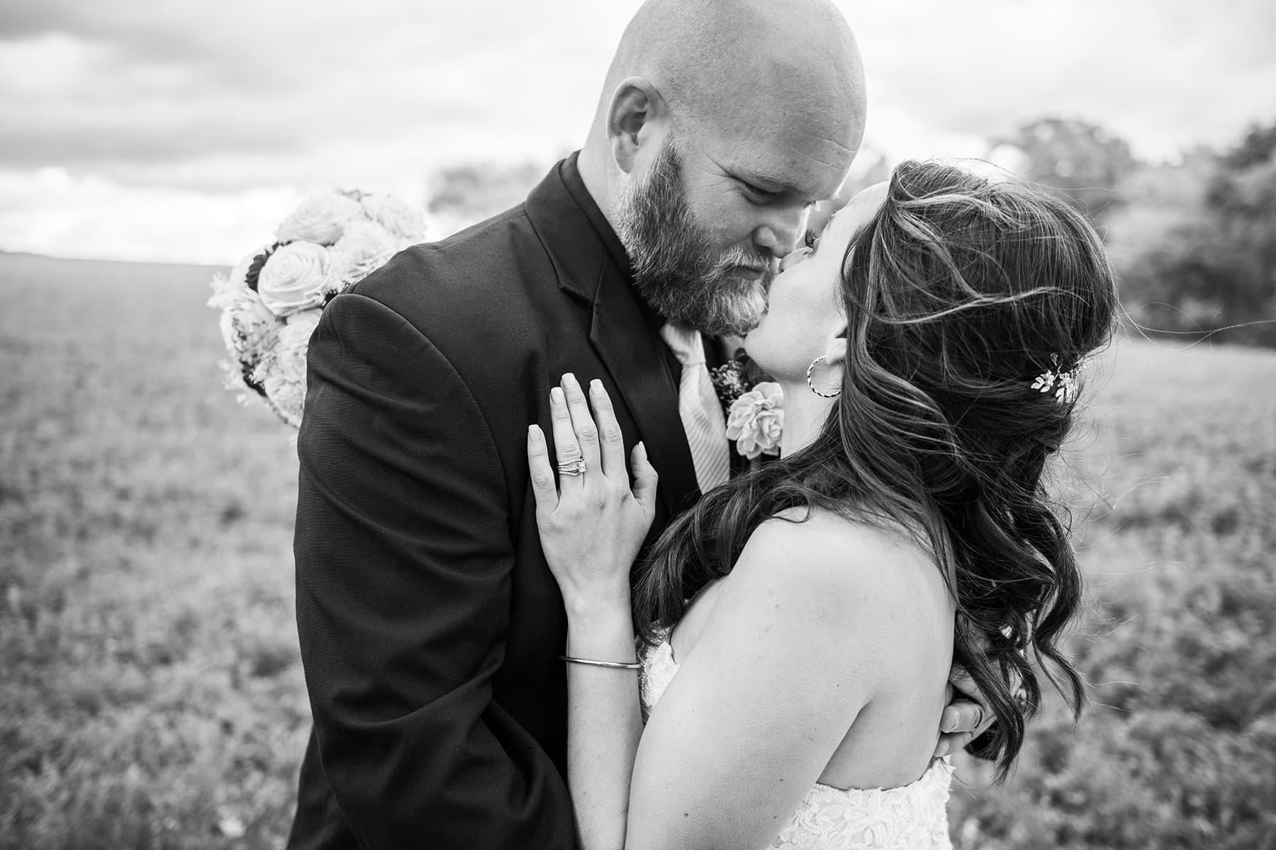 Close-up detail shot of the bride and groom kissing, featured in Wisconsin wedding planning tips