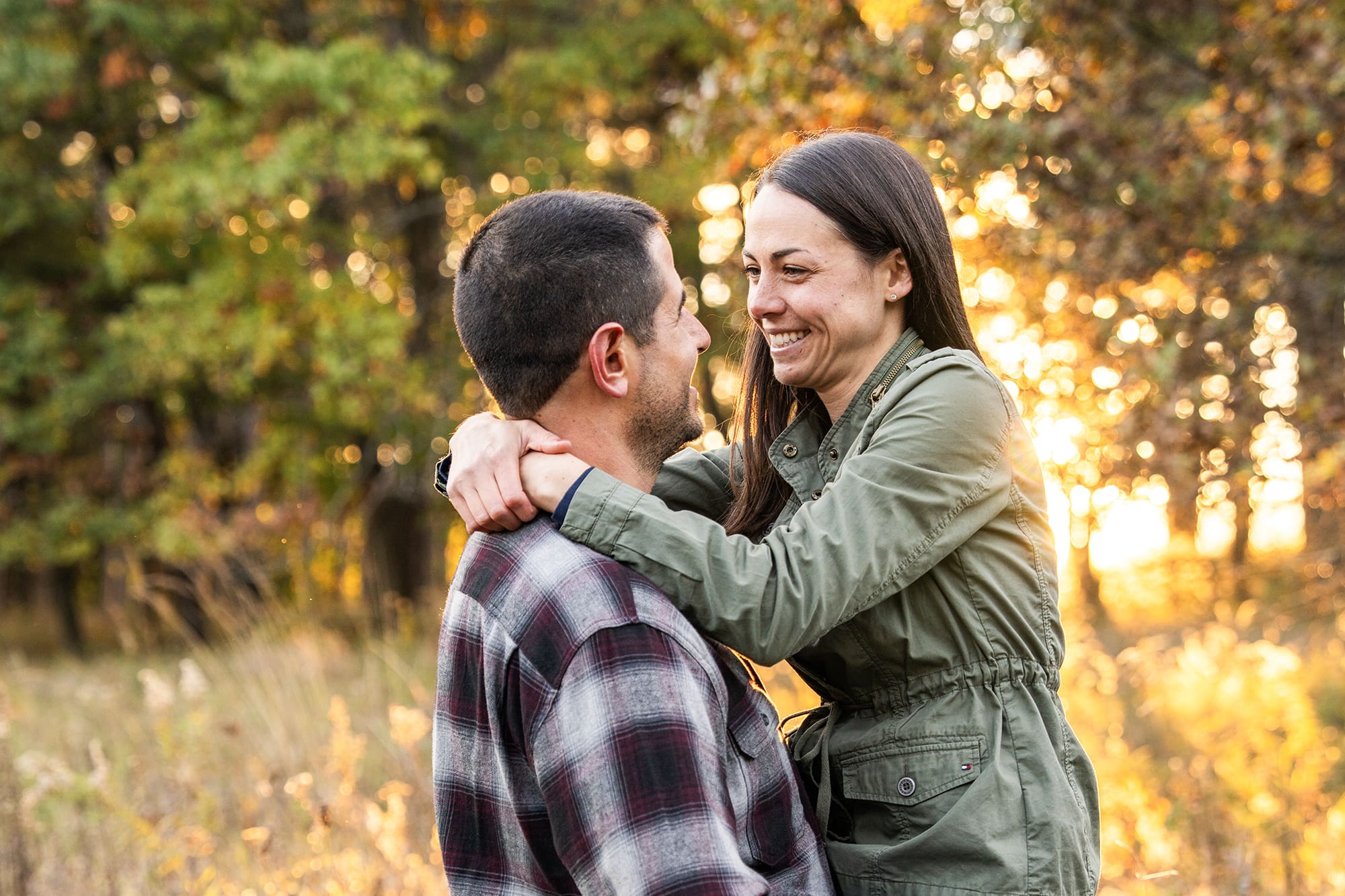 Engaged Delafield couple laughing together during engagement photos in Waukesha County