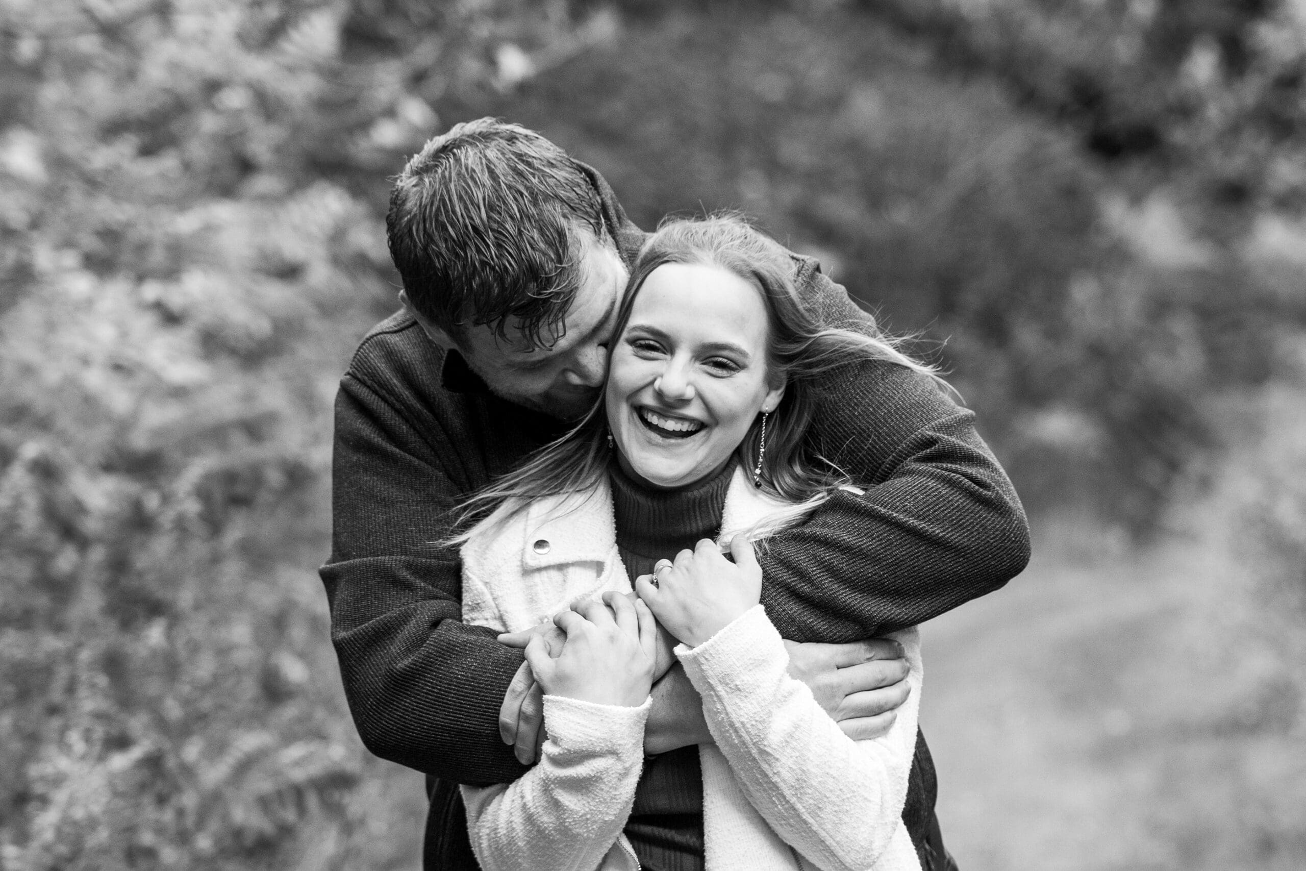 Engaged Wisconsin couple laughing together during a session, showing how to prepare for an engagement session in Wisconsin