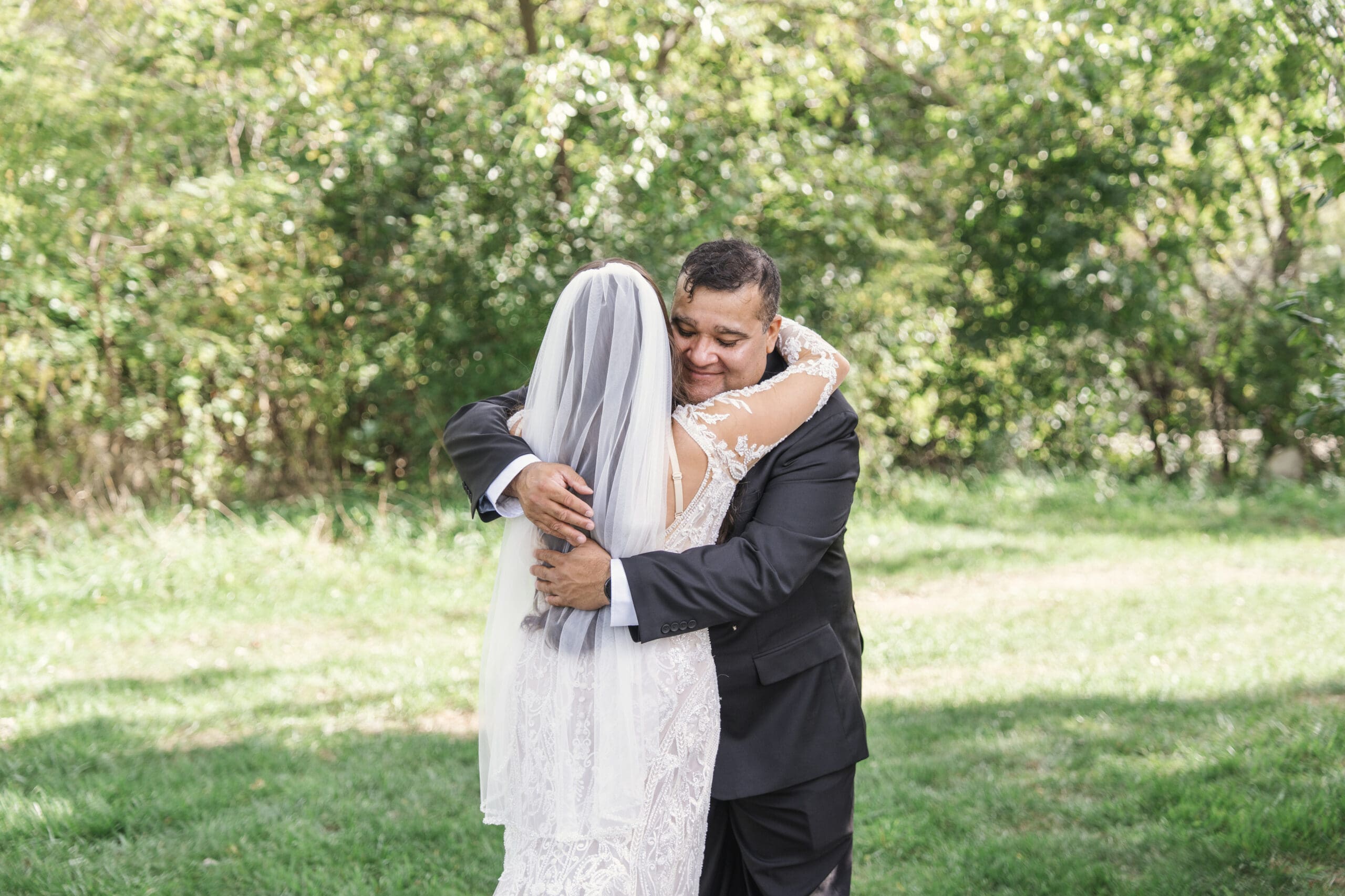 Father and bride embracing after first look reveal. 