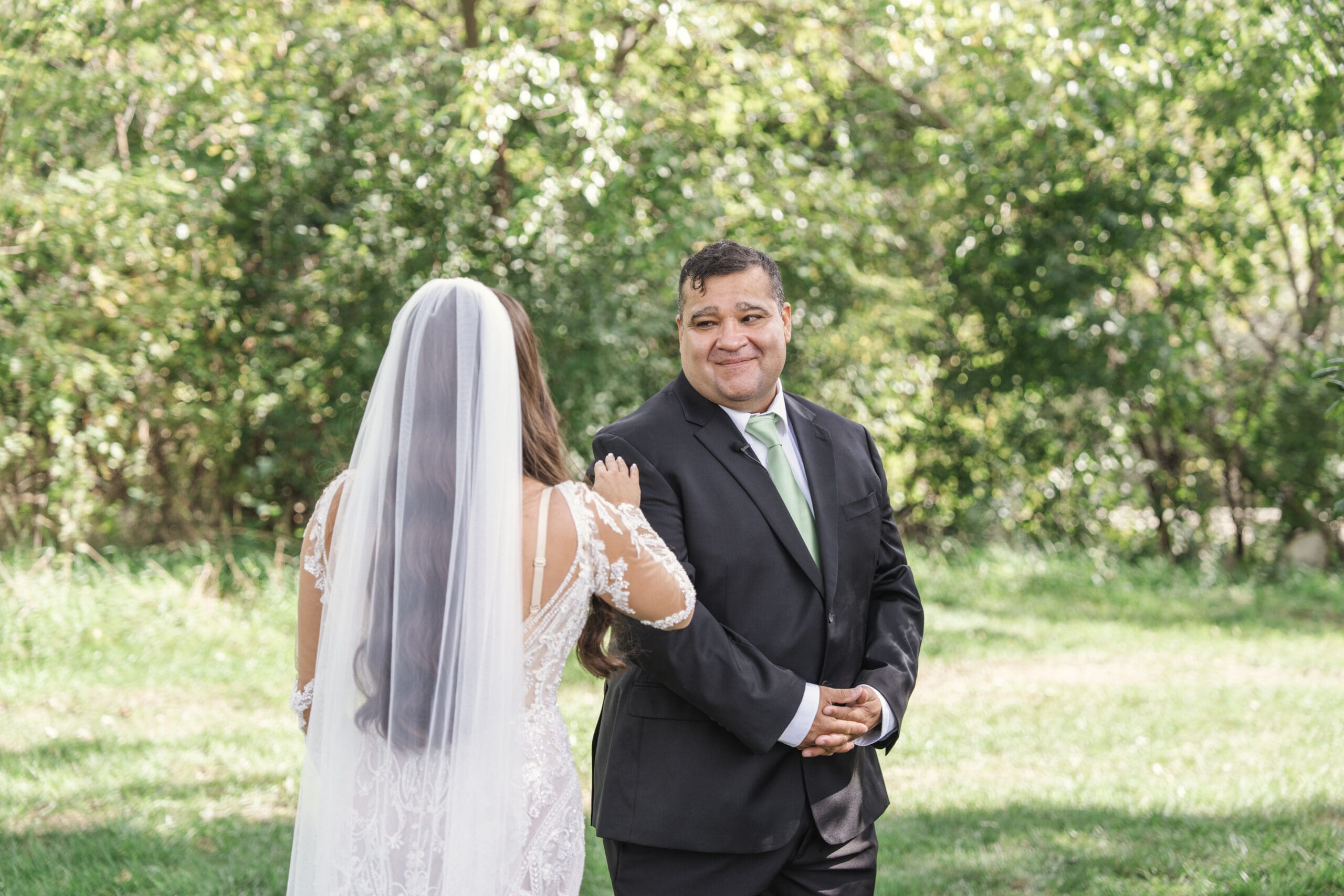 Bride seeing her dad for the first time in her wedding dress