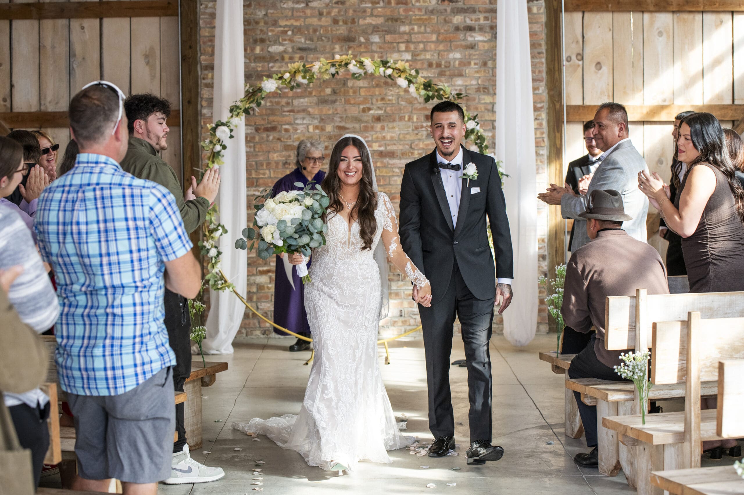 Groom and bride descending ceremony aisle