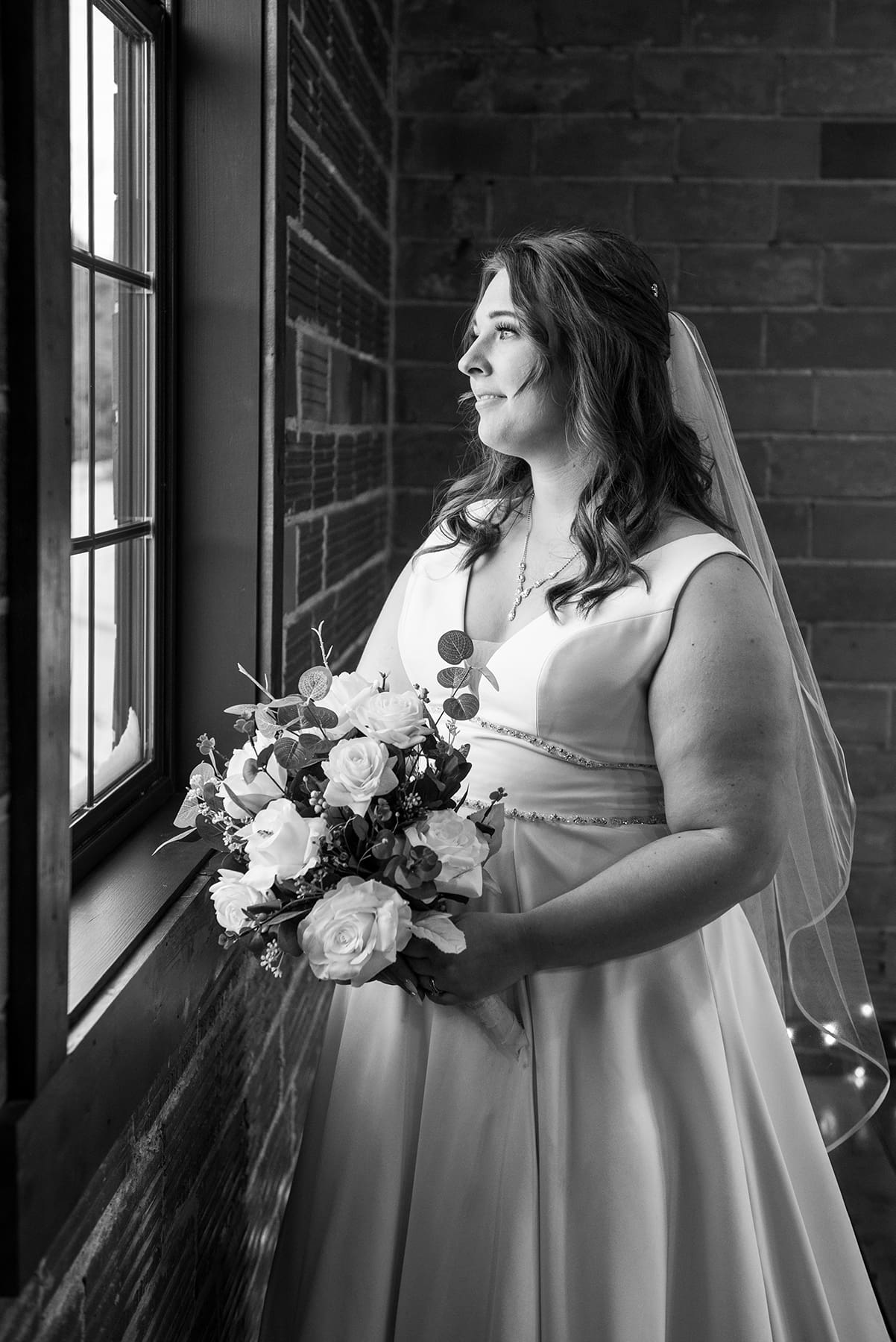Hartland bride looking out window before WI wedding ceremony
