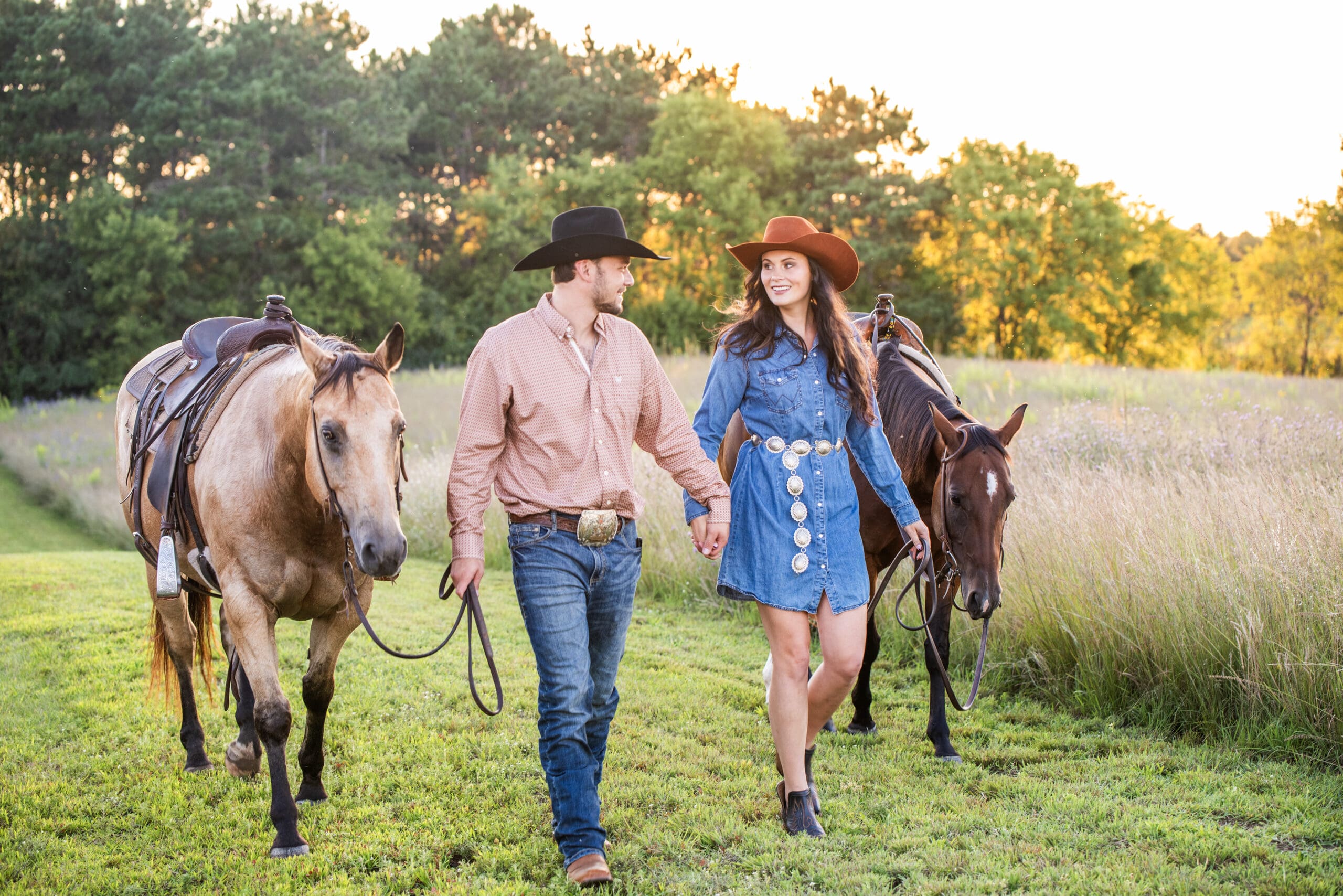 Hartland couple walking with their horses during their engagement session