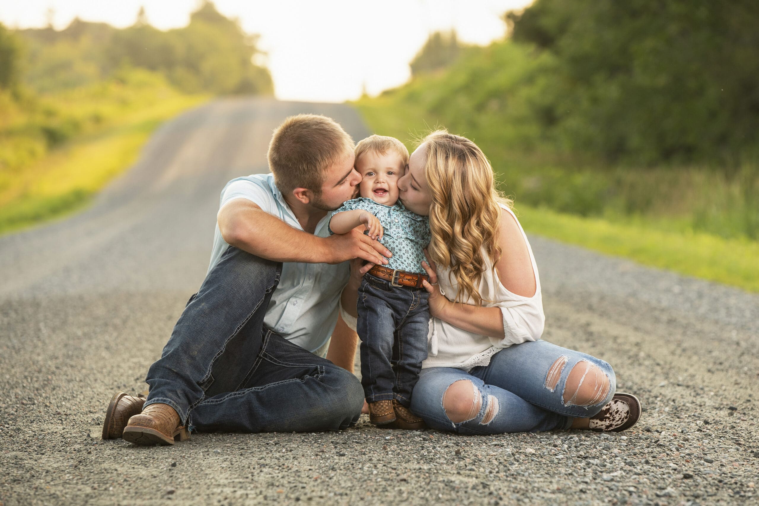 Hartland parents kissing their son during summer family session.