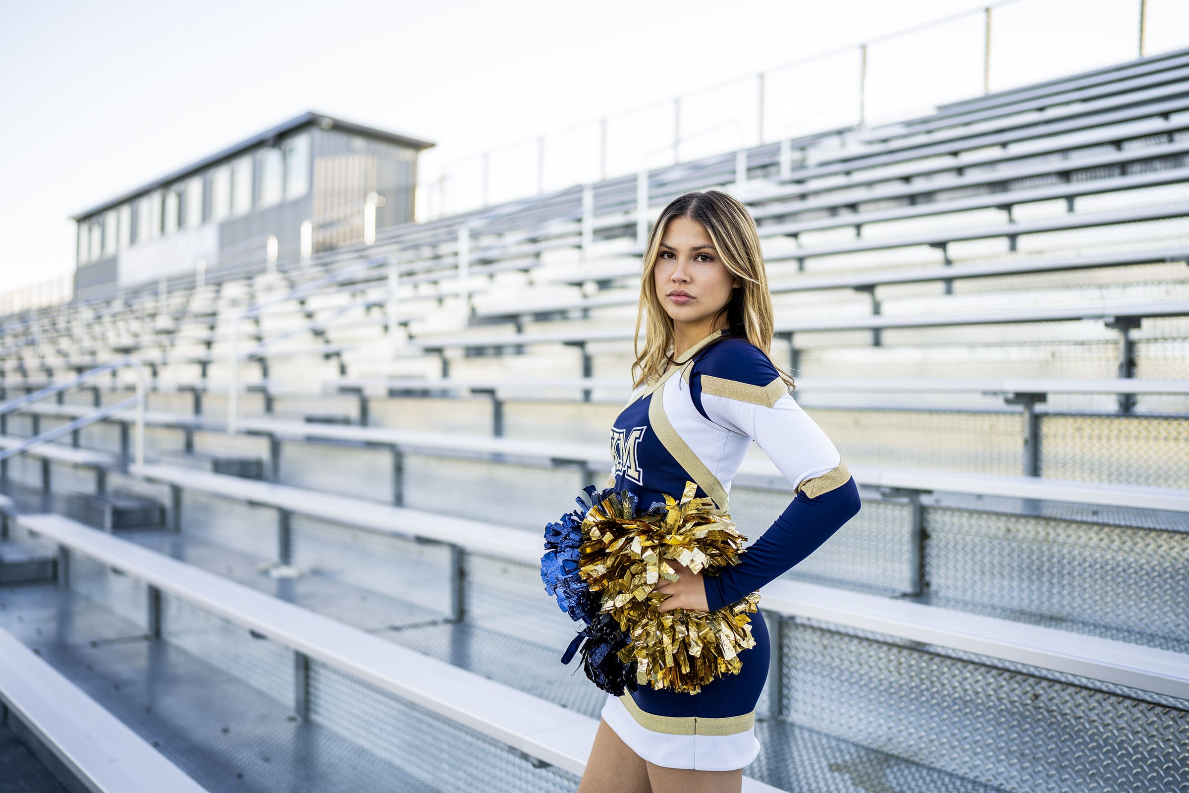 Kettle Moraine girl senior standing in her cheerleading outfit with confidence from using the senior photo tips.