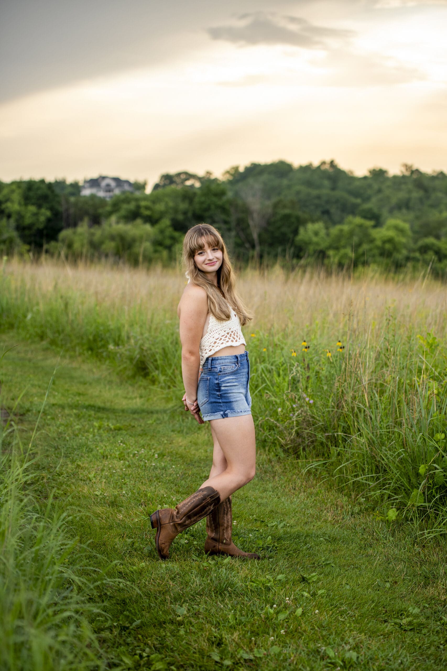 Kettle Moraine senior posing in field. 