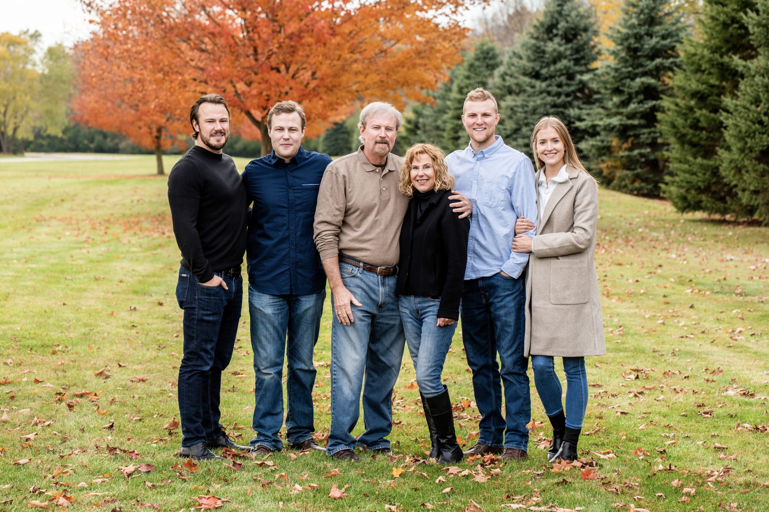 Family portraits in a field during fall captured at a popular family photo location in Wisconsin
