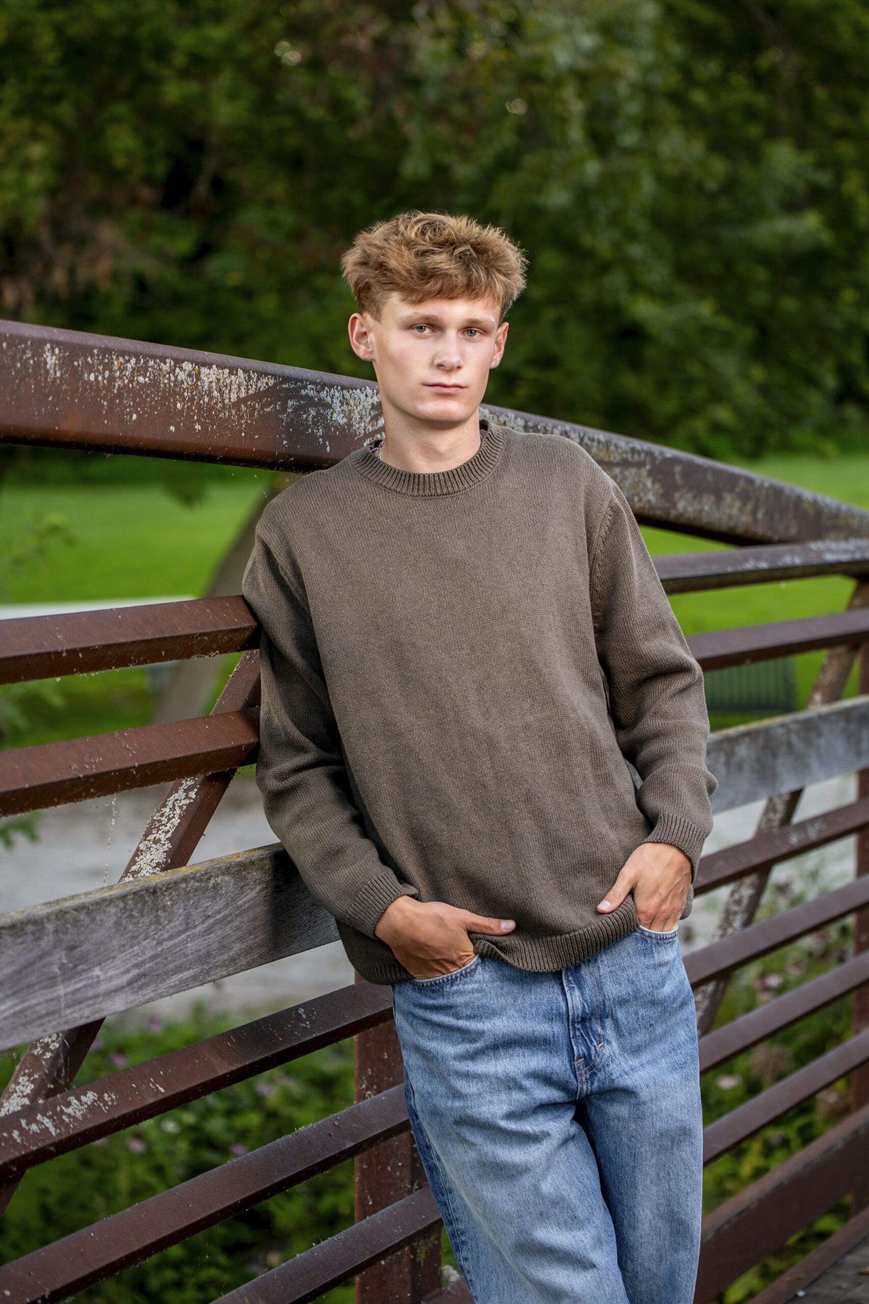 Oconomowoc senior leaning against bridge at the Fish Hatchery in Delafield. 