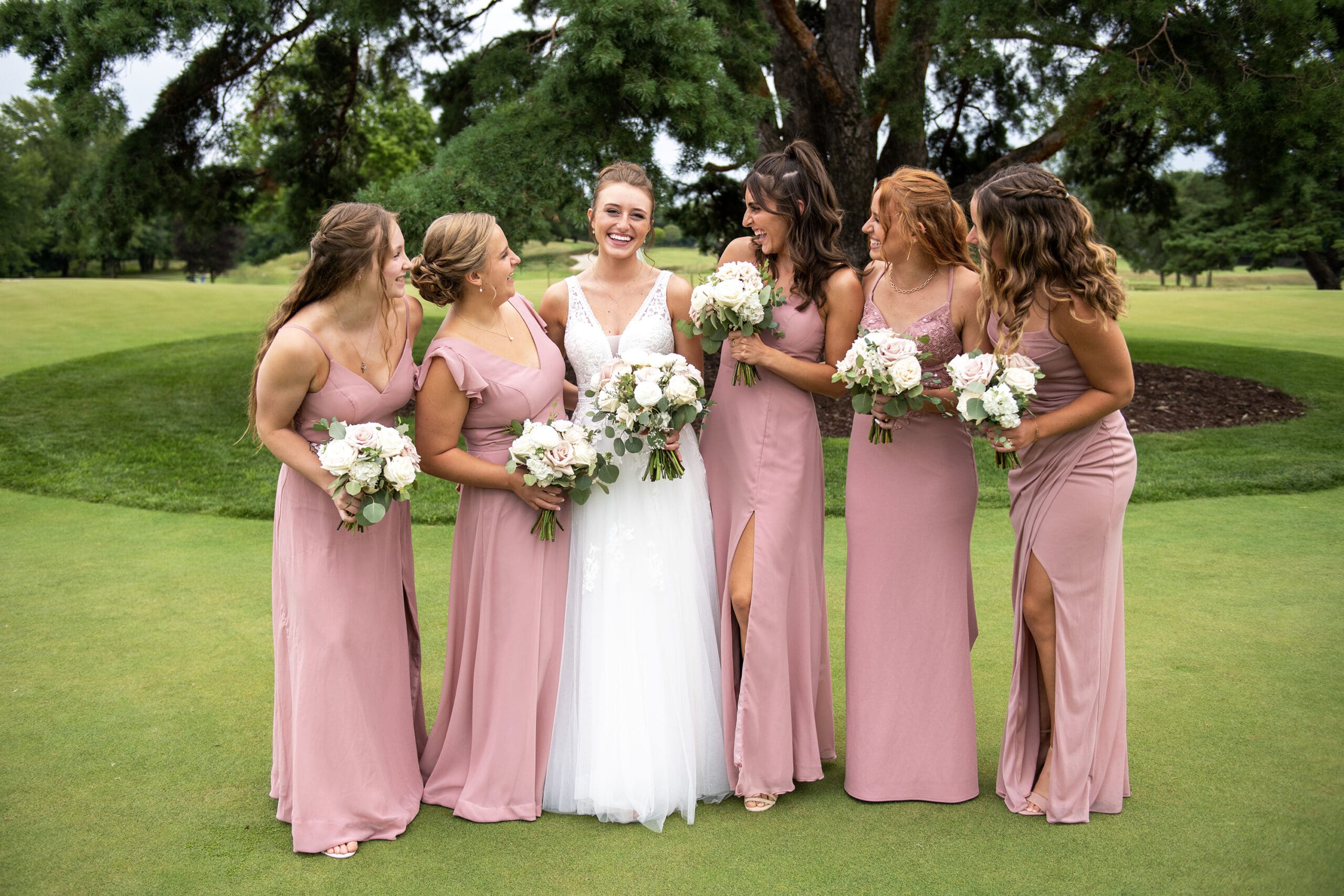 Oconomowoc bride and her bridesmaids laughing 