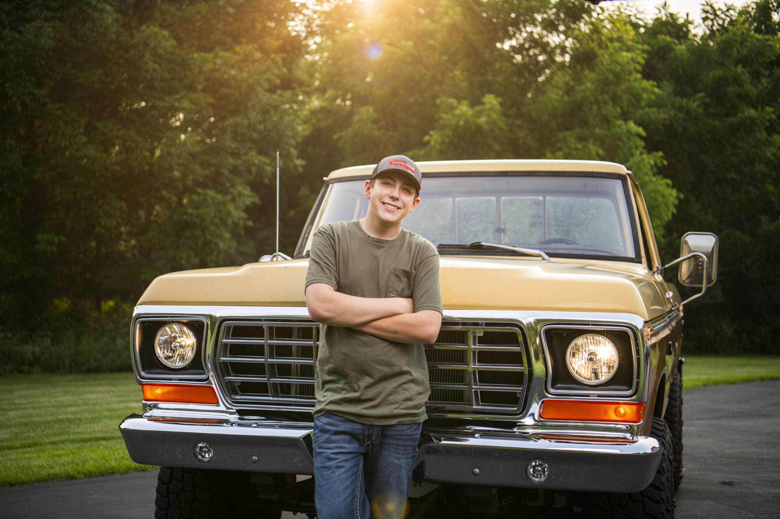 Oconomowoc senior leaning against his truck.