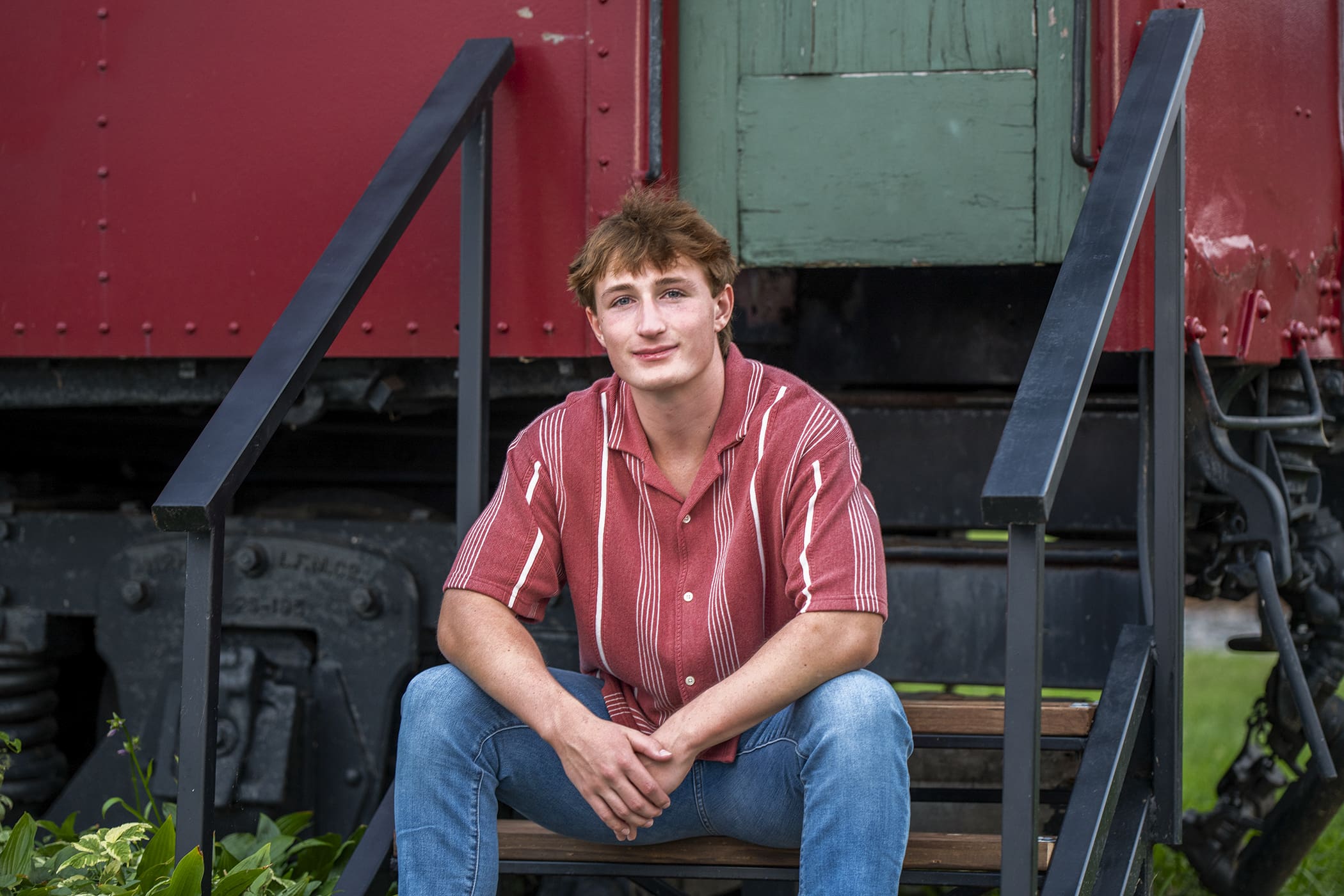Oconomowoc senior sitting on steps in downtown.