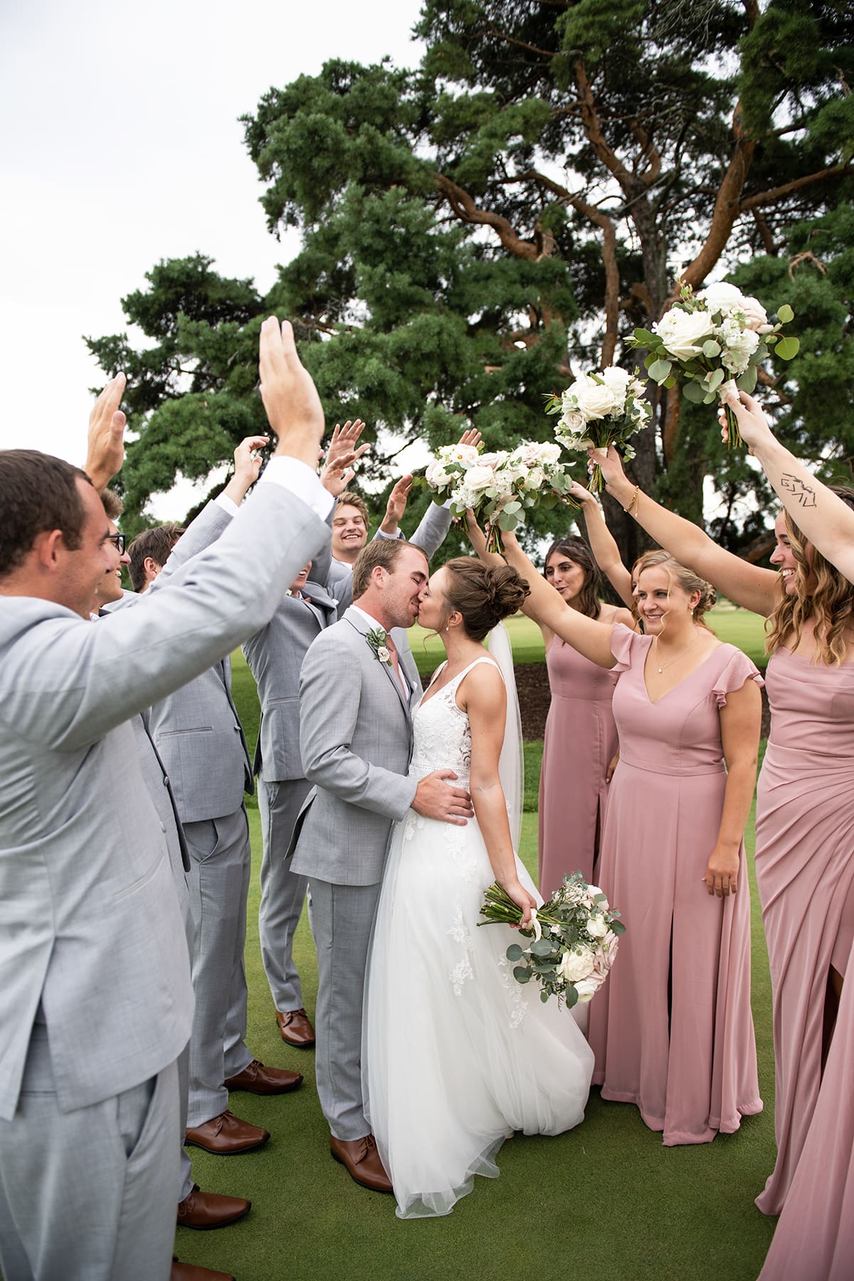 Wedding party cheering and celebrating at the 1896 Room wedding venue in Oconomowoc, Wisconsin