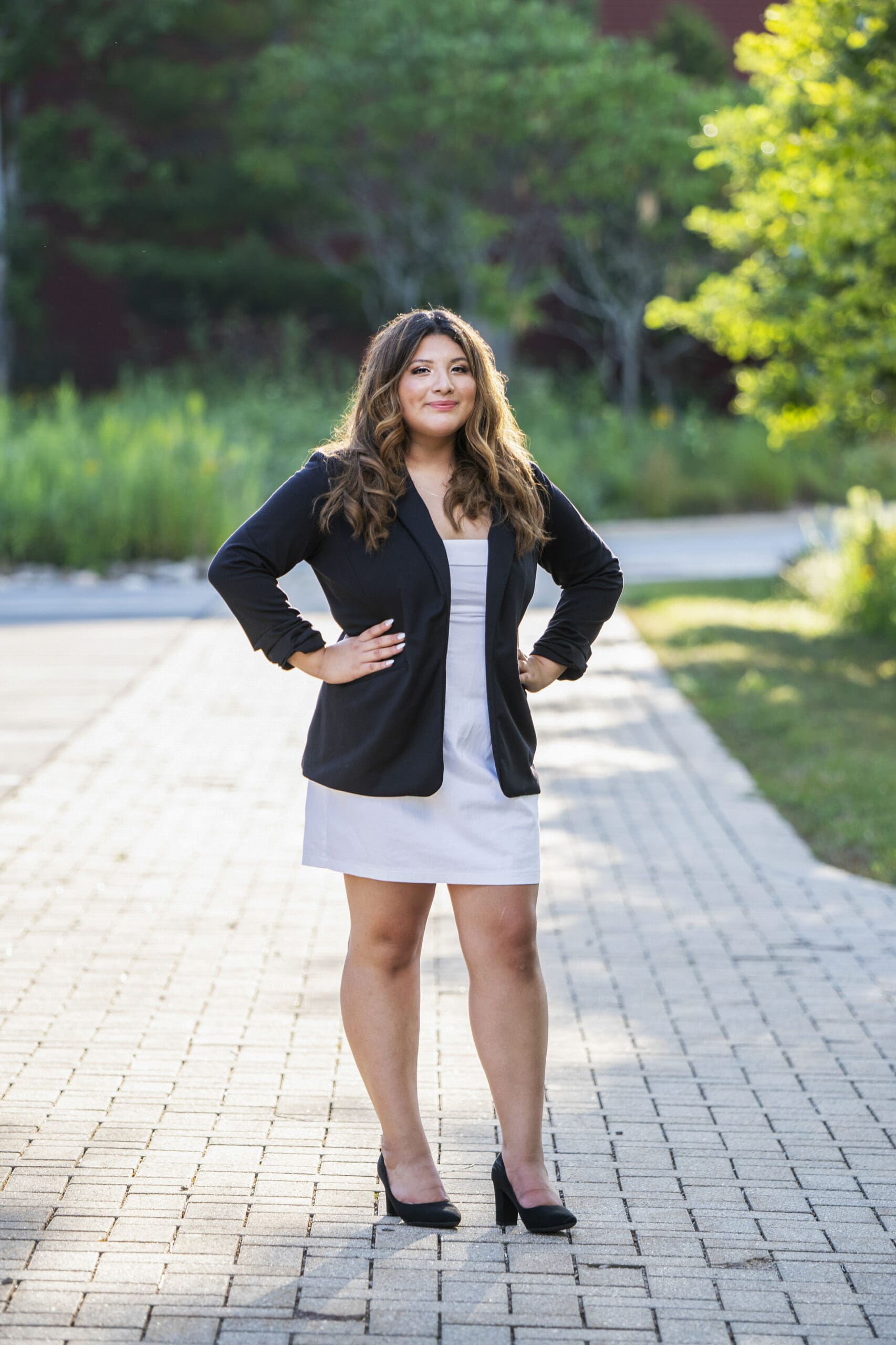Pewaukee senior standing on sidewalk - a great senior picture location in WI. 