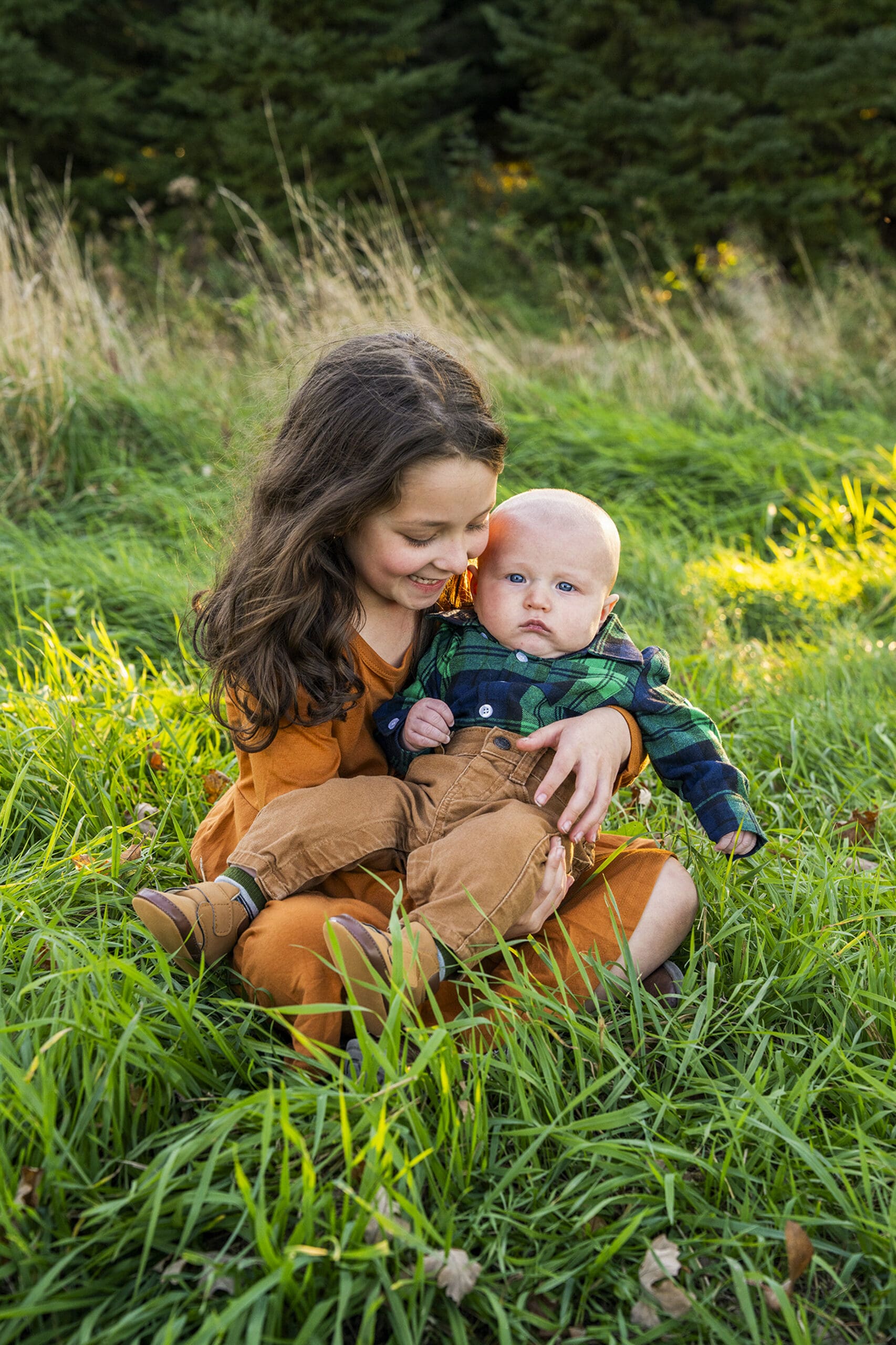 Sister holding her brother in Waukesha for family photo session.