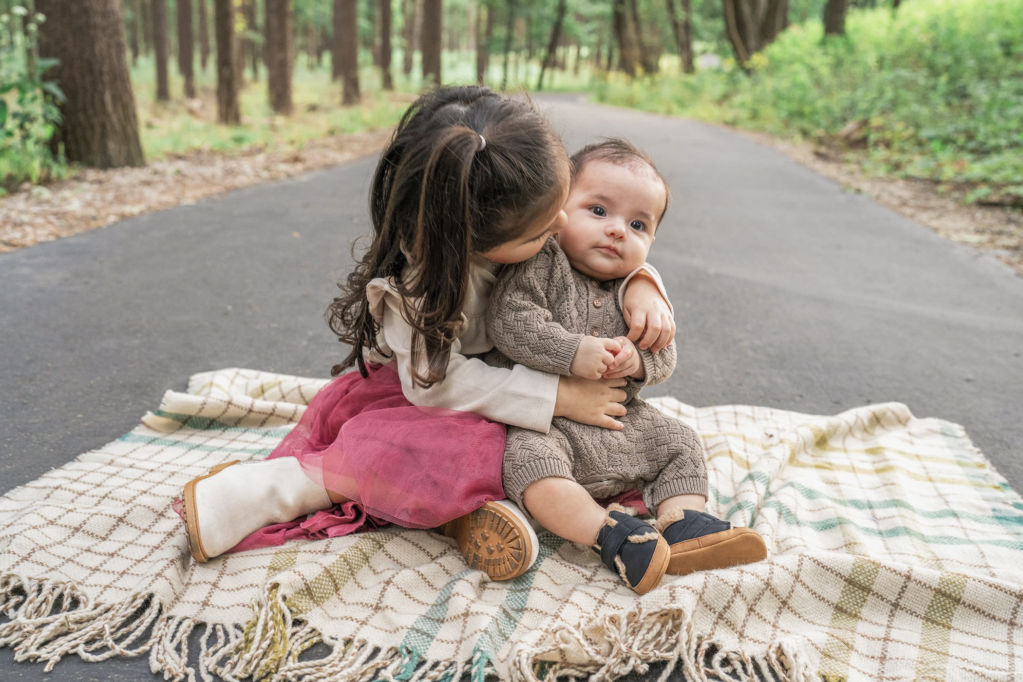 Big sister giving her sibling a kiss during family photos in Delafield, WI. 