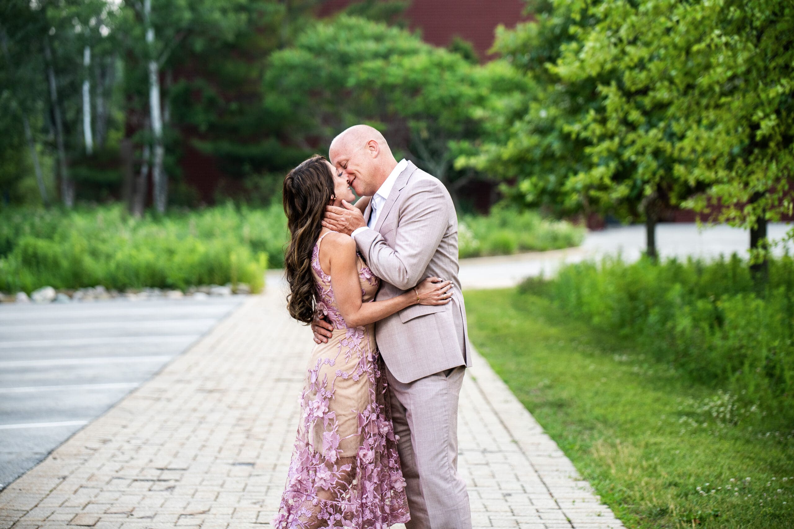 Southeast WI couple kissing on sidewalk