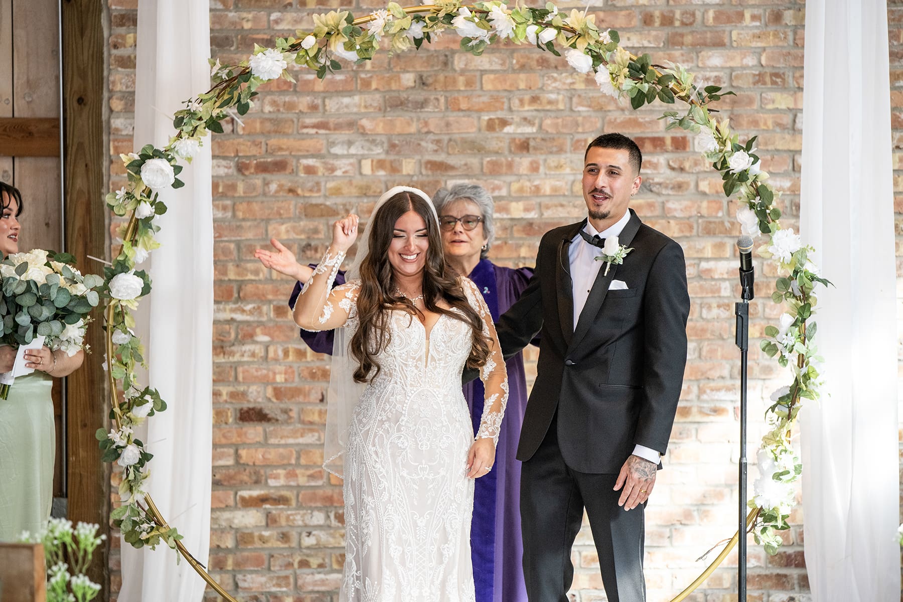 Bride and groom cheering after just getting married 
