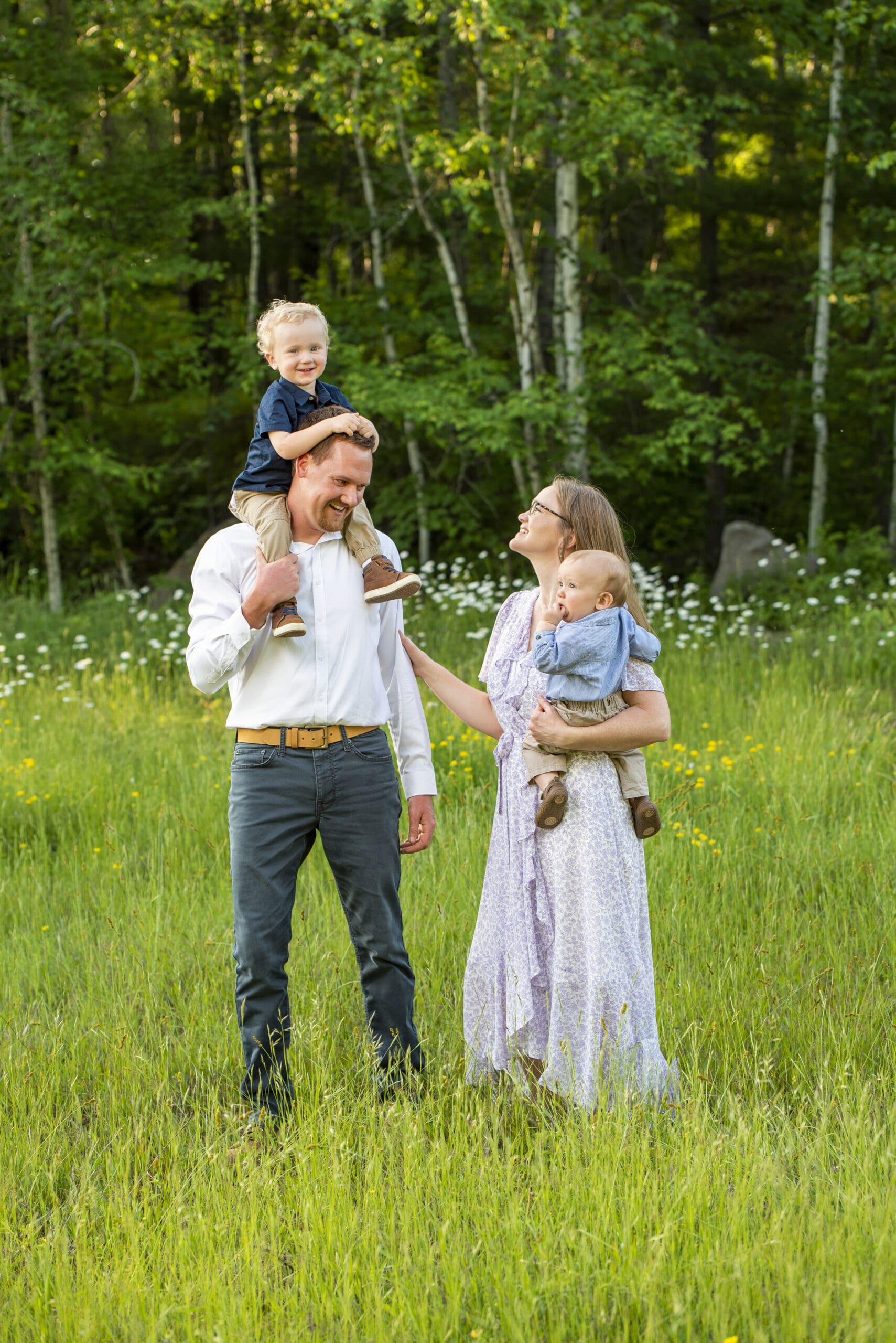 Waukesha family laughing in field during family photo session.