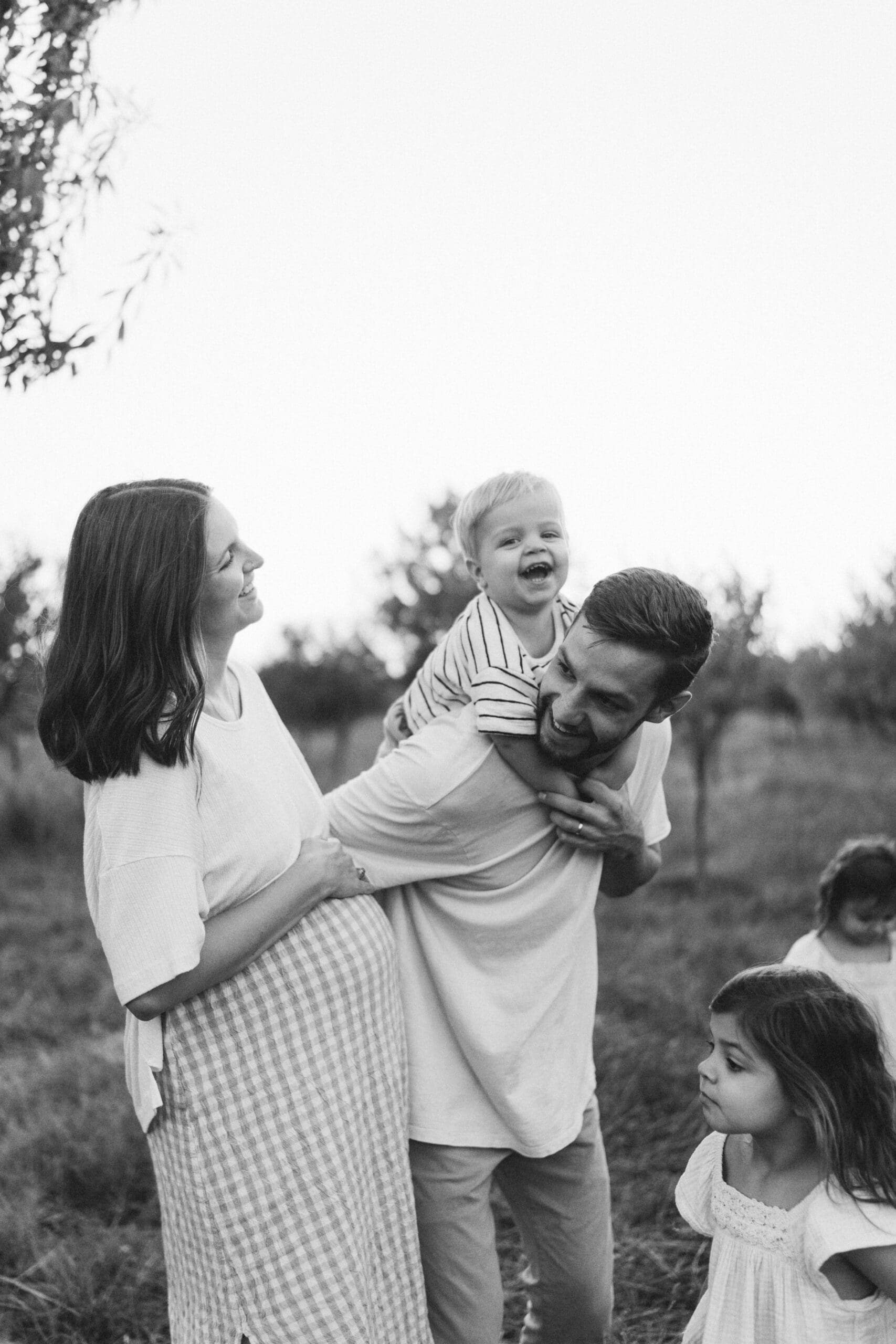 Family photography FAQ image of Waukesha parents and children interacting naturally.