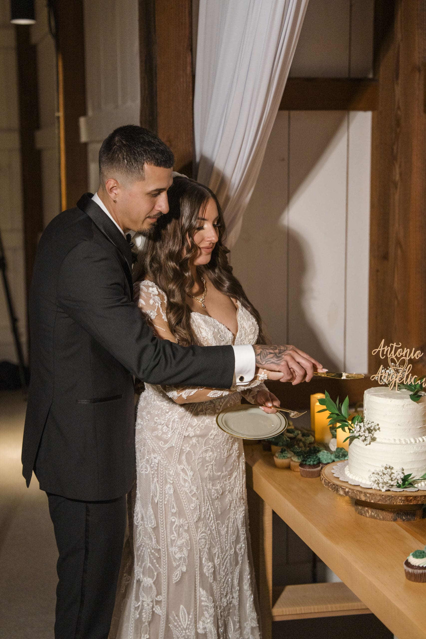 Groom and bride cutting cake during wedding reception 
