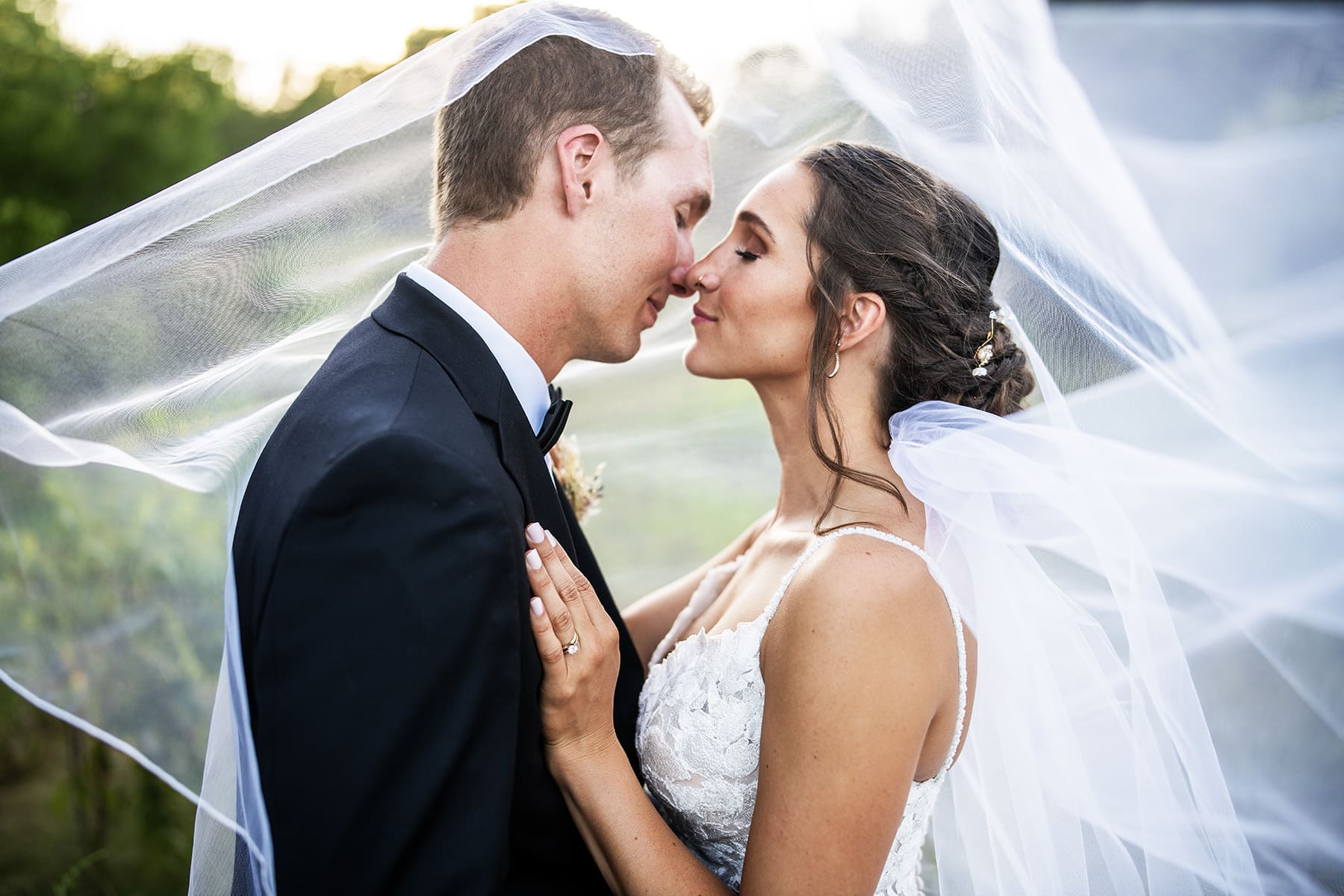 Bride and groom touching noses under a sheer veil at one of the most romantic Southeast Wisconsin wedding venues