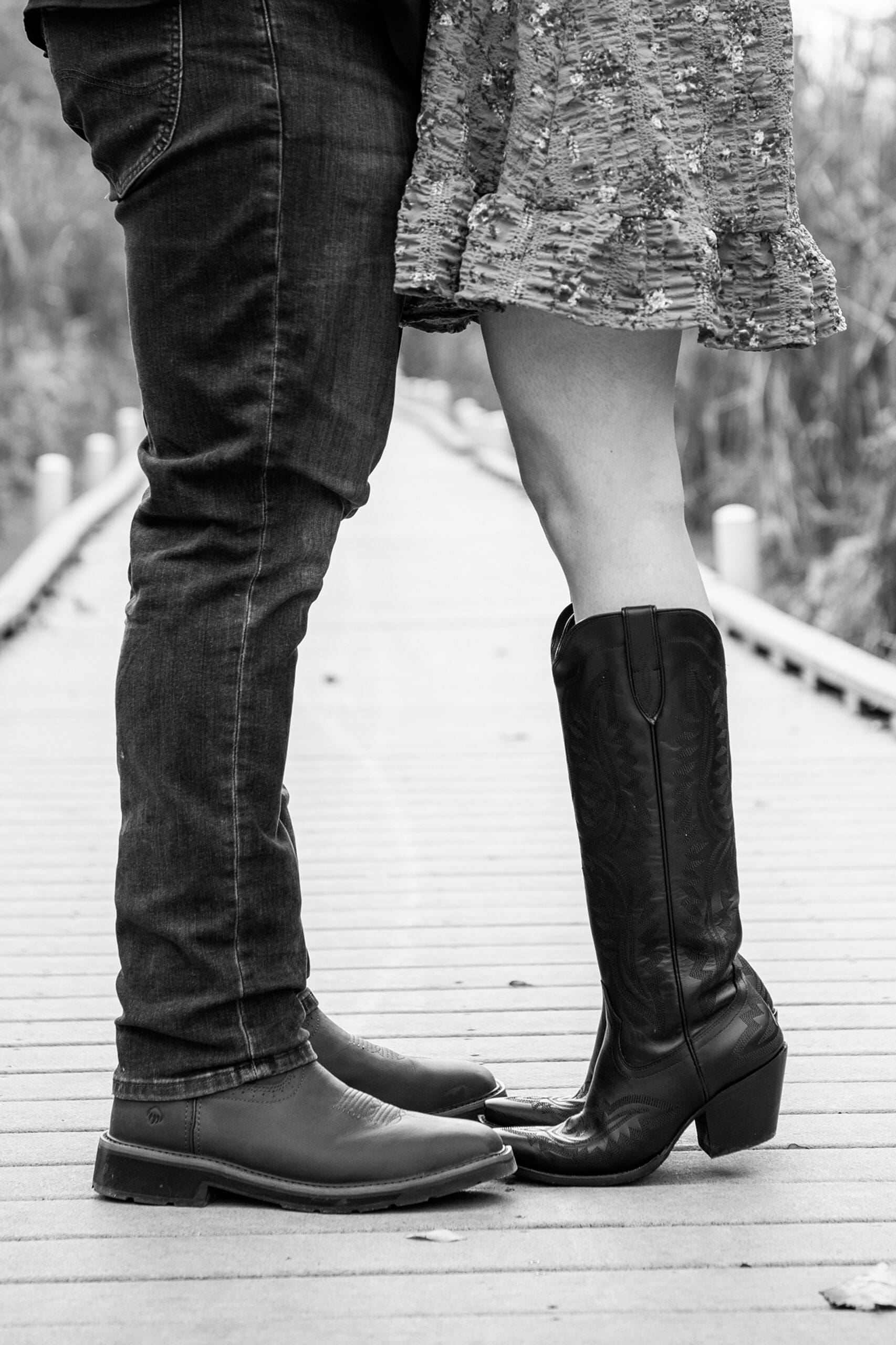 Detail photo of engaged couples cowboy boots.